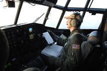 Maj. Robert Fairbanks and members of his C-130 crew deploy 3,000 gallons of fire retardant over the Poomacha Fire in North San Diego County, Calif. The reservists are assigned to the 302nd Airlift Wing, Peterson Air Force Base, Colo., and launched their firefighting mission from Channel Islands Air National Guard Station, Calif., Oct. 24, 2007. (U.S. Air Force photo/Tech. Sgt. Roy A. Santana)