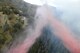 An Air Force Reserve C-130 drops fire retardant onto a wildfire in North San Diego County, Calif., Oct. 24, 2007. The aircraft and crew are assigned to the 302nd Airlift Wing, Peterson Air Force Base, Colo. (U.S. Air Force photo/Tech. Sgt. Roy A. Santana)