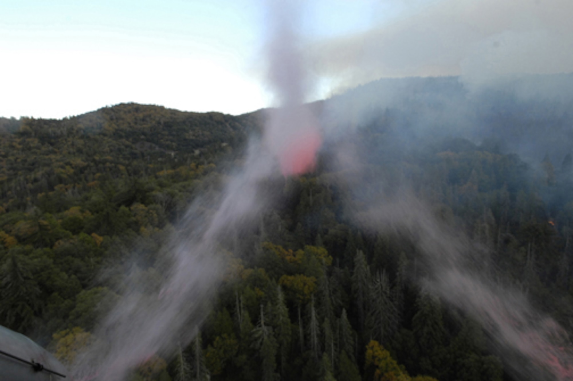 Fire retardant is dumped from a specially equipped C-130 aircraft onto a wildfire in North San Diego County, Calif., Oct. 24, 2007. Air Force reservists from the 302nd Airlift Wing, Peterson Air Force Base, Colo., are participating in the Southern California firefighting effort. (U.S. Air Force photo/Tech. Sgt. Roy A. Santana) 