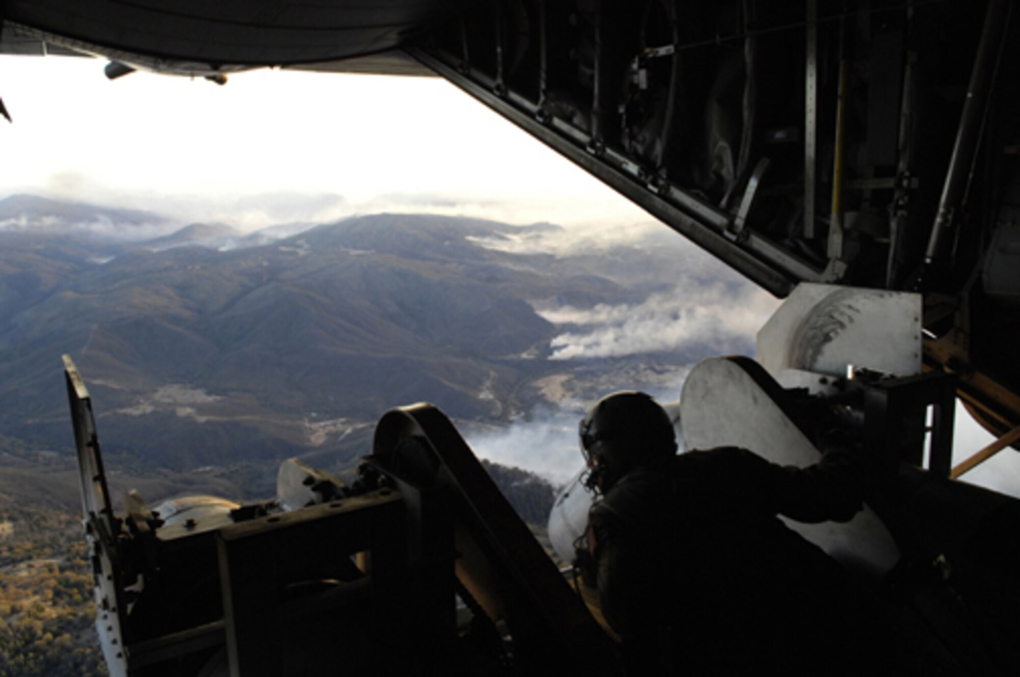 Tech. Sgt. Lamont Wood checks the positioning of the nozzles on a specially equipped C-130 prior to deploying 3,000 gallons of fire retardant over a wildfire in North San Diego County, Calif., Oct. 24, 2007. Sergeant Wood and other reservists on the crew are from the 302nd Airlift Wing, Peterson Air Force Base, Colo. (U.S. Air Force photo/Tech. Sgt. Roy A. Santana)

