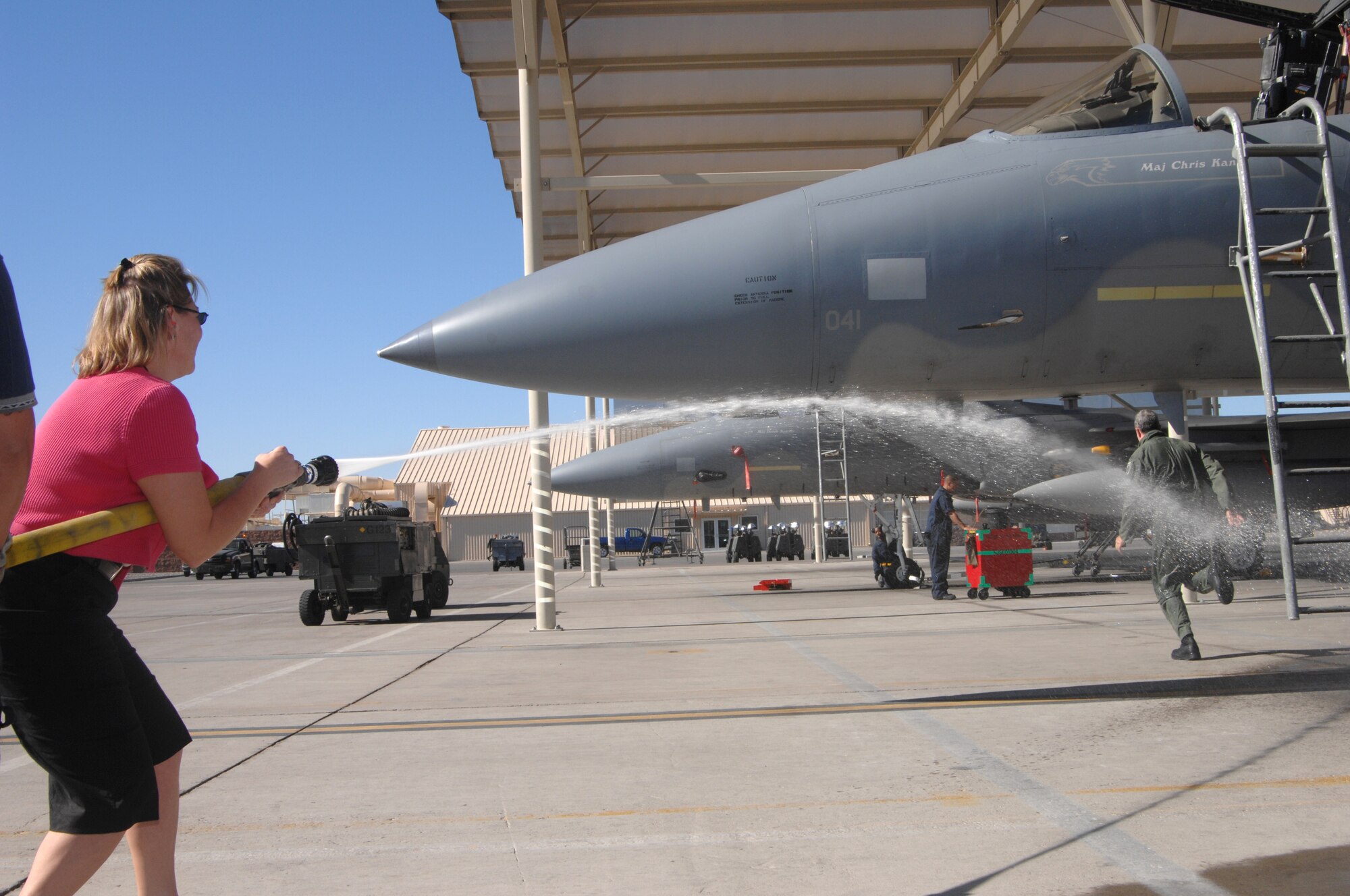 Mrs. Kelley Howe, AFOTEC Detachment 6 commander's secretary, sprays down Col. Jimmy Clark, AFOTEC Detachment 6 commander after completing his 3,000th flying hour milestone in an F-15 Oct. 19, Nellis AFB, Nev.
(U.S. Air Force Photo by Senior Airman Larry E. Reid Jr.)