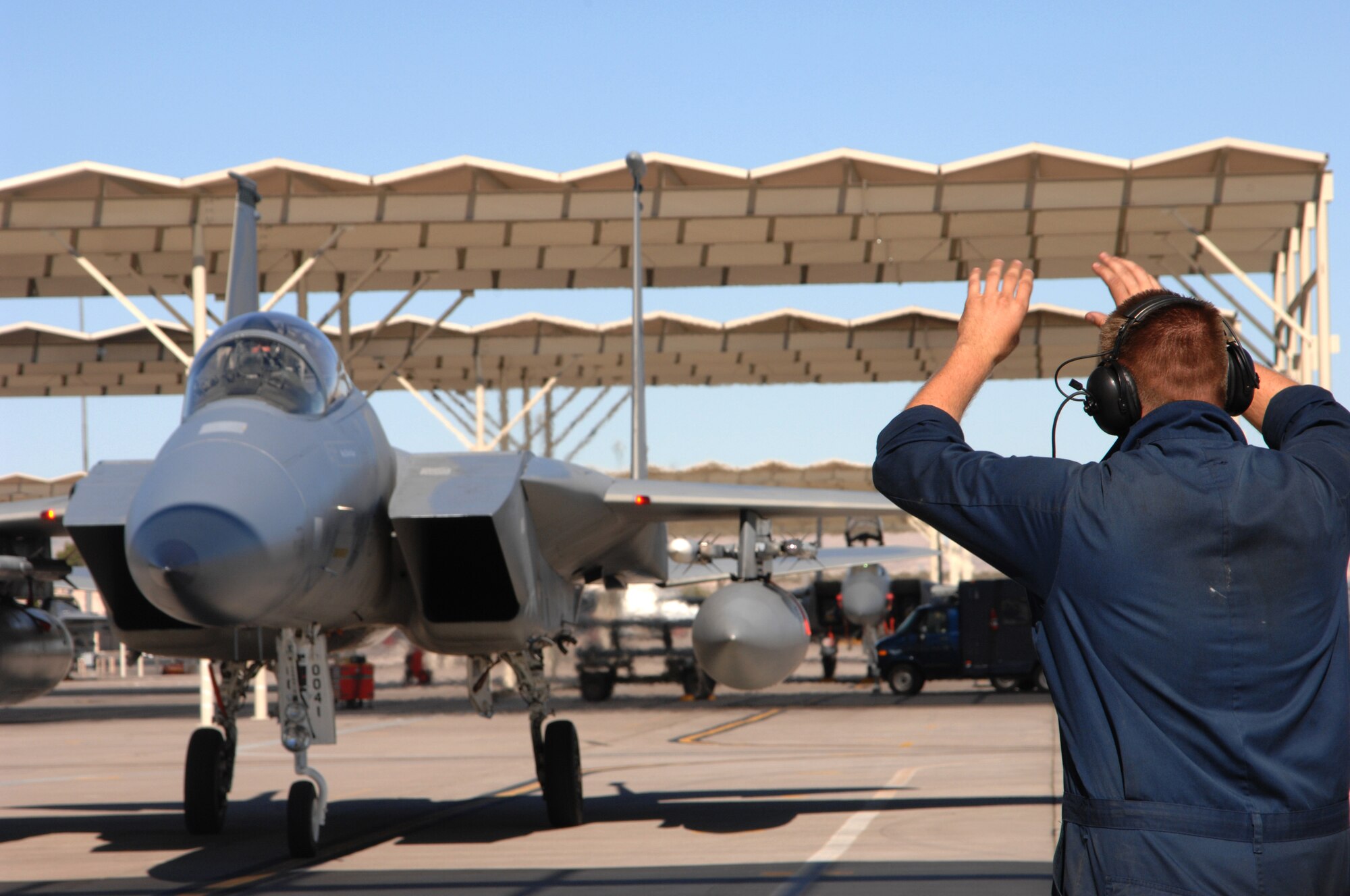A crew chief marshalls in AFOTEC Detachment 6 commander, Col. Jimmy Clark, as he completes his 3,000th flying hour milestone in the F-15 Oct. 19, Nellis AFB, Nev.
(U.S. Air Force Photo by Senior Airman Larry E. Reid Jr.)