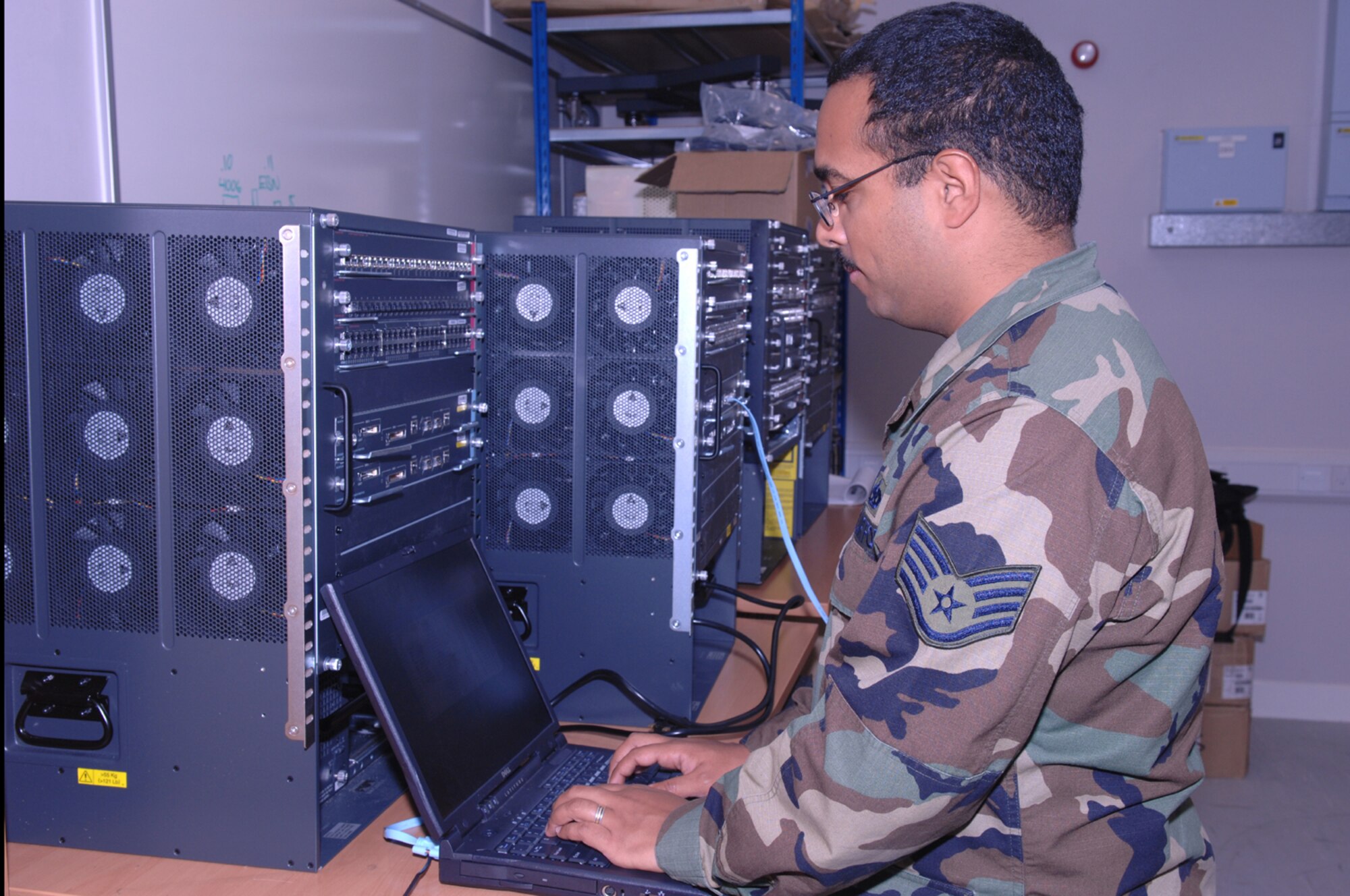 Staff Sgt. Julio Gonzalez, 48th Communications Squadron network infrastructure technician, prepares to connect a console cable to configure the network switch Oct 23 at RAF Lakenheath, England.   Staff Sgt Gonzalez performs routine maintenance training on the switch to ensure the base maintains connectivity. (U.S. Air Force photo by Tech. Sgt. Sabrina Johnson)