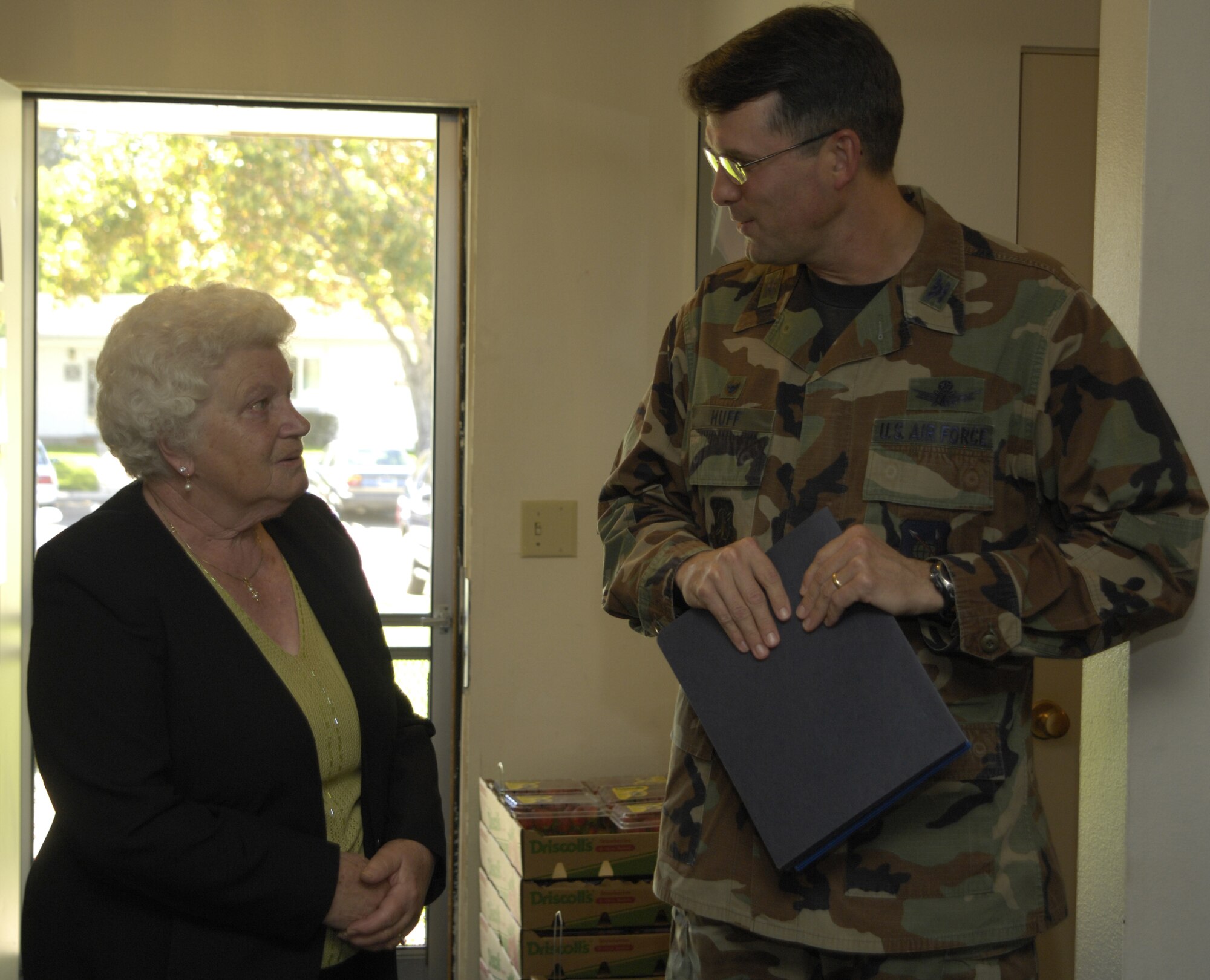 Emilie Acklen, former Vandenberg AFB housekeeping room attendant, talks with Col. Benjamin Huff, 30th Mission Support Group commander, at her retirement ceremony here on Oct. 19. Ms. Acklen has been a room attendant at Vandenberg since 1969.