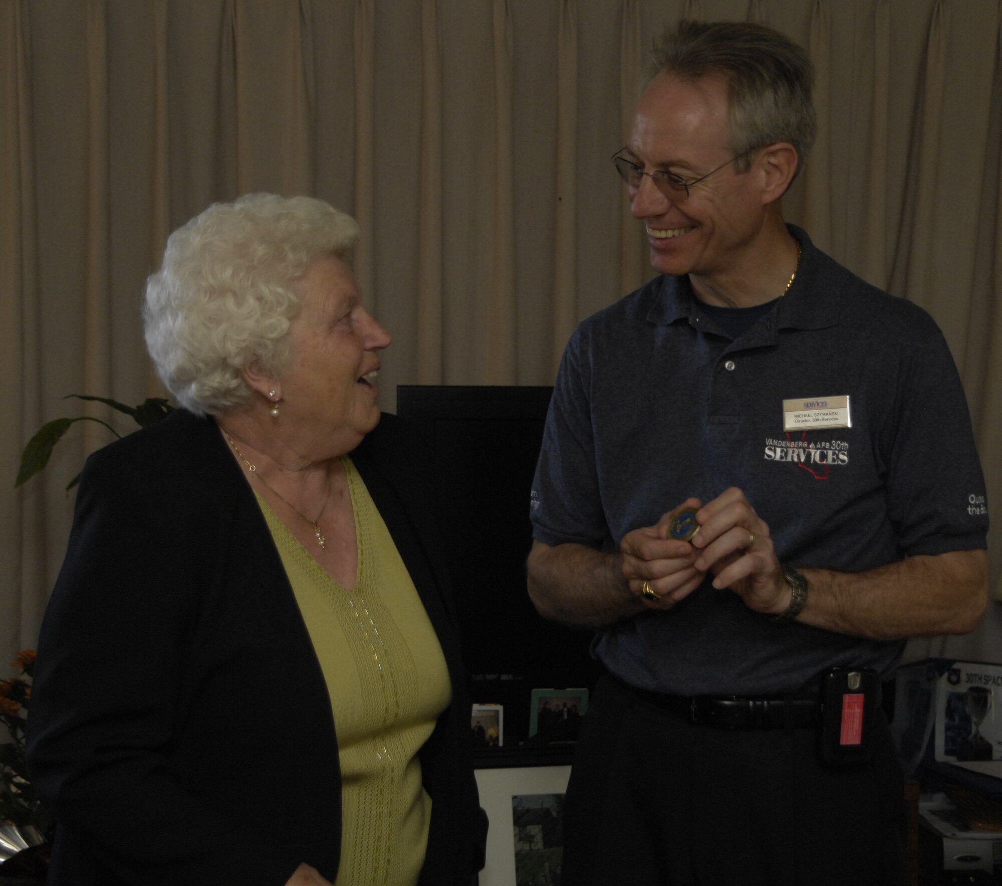 Emilie Acklen, former Vandenberg AFB housekeeping room attendant, shares a laugh with co-worker, Michael Szymanski, 30th Space Wing Services director, at her retirement ceremony here on Oct. 19. Ms. Acklen has been a room attendant at Vandenberg since 1969.