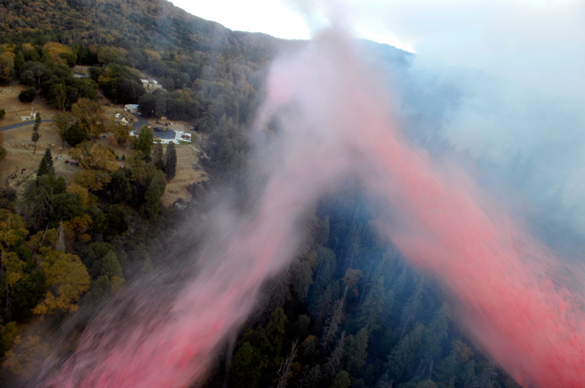 Approximately 3,000 gallons of fire retardant is deployed Oct. 24 over the Poomacha Fire in North San Diego County, Calif. The C-130 Hercules and crew are assigned to the 302nd Airlift Wing from Peterson Air Force Base, Colo. The aircraft launched from Channel Islands Air National Guard Station, Calif. Air Force Reserve Command officials sent two of its designated firefighting C-130H3 aircraft to help battle the raging wildfires in Southern California. (U.S. Air Force photo/Tech. Sgt. Roy. A. Santana) 
