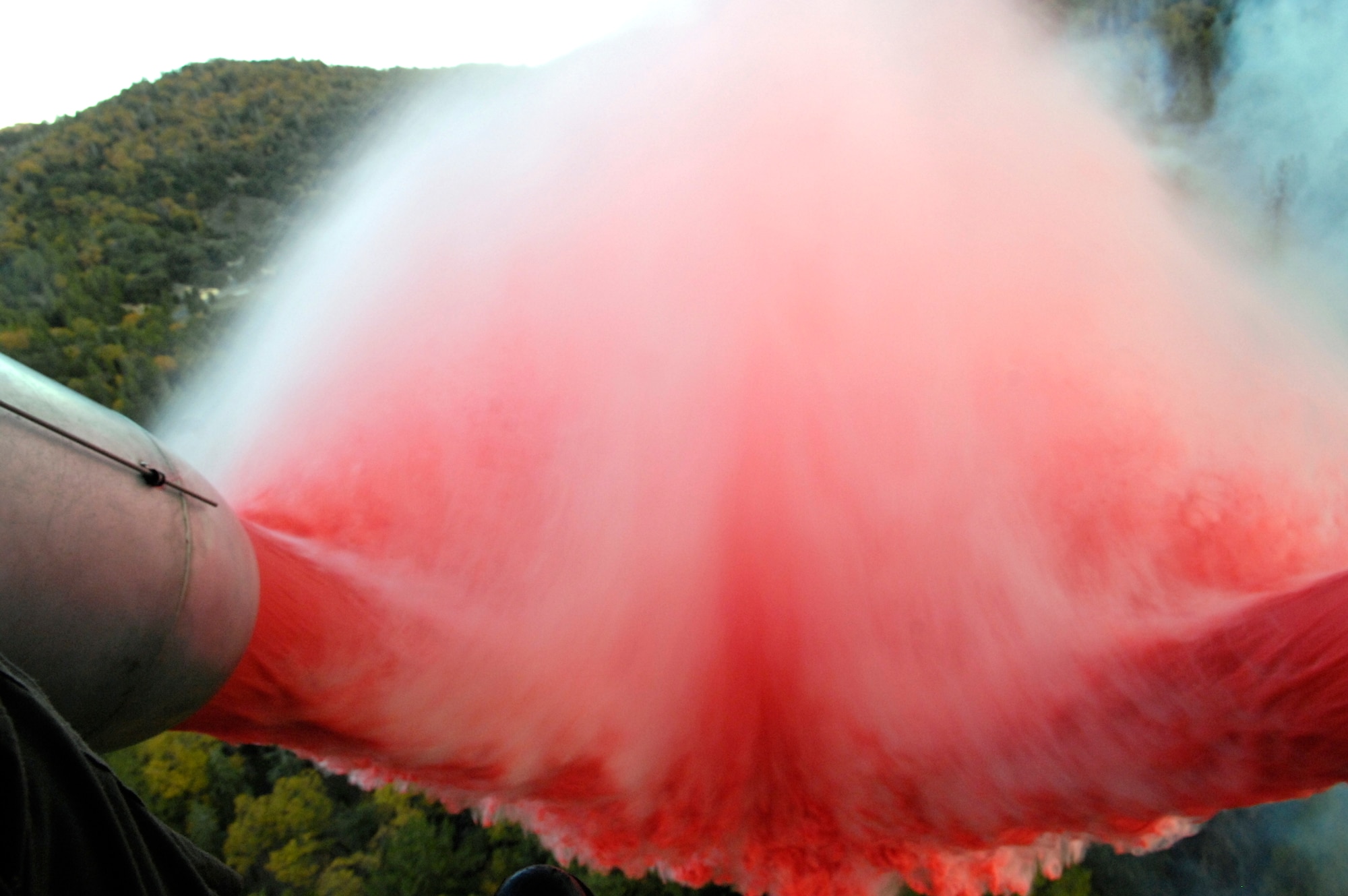 Approximately 3,000 gallons of fire retardant is deployed Oct. 24 over the Poomacha Fire in North San Diego County, Calif. The C-130 Hercules and crew are assigned to the 302nd Airlift Wing from Peterson Air Force Base, Colo. The aircraft launched from Channel Islands Air National Guard Station, Calif. Air Force Reserve Command officials sent two of its designated firefighting C-130H3 aircraft to help battle the raging wildfires in Southern California. (U.S. Air Force photo/Tech. Sgt. Roy. A. Santana) 
