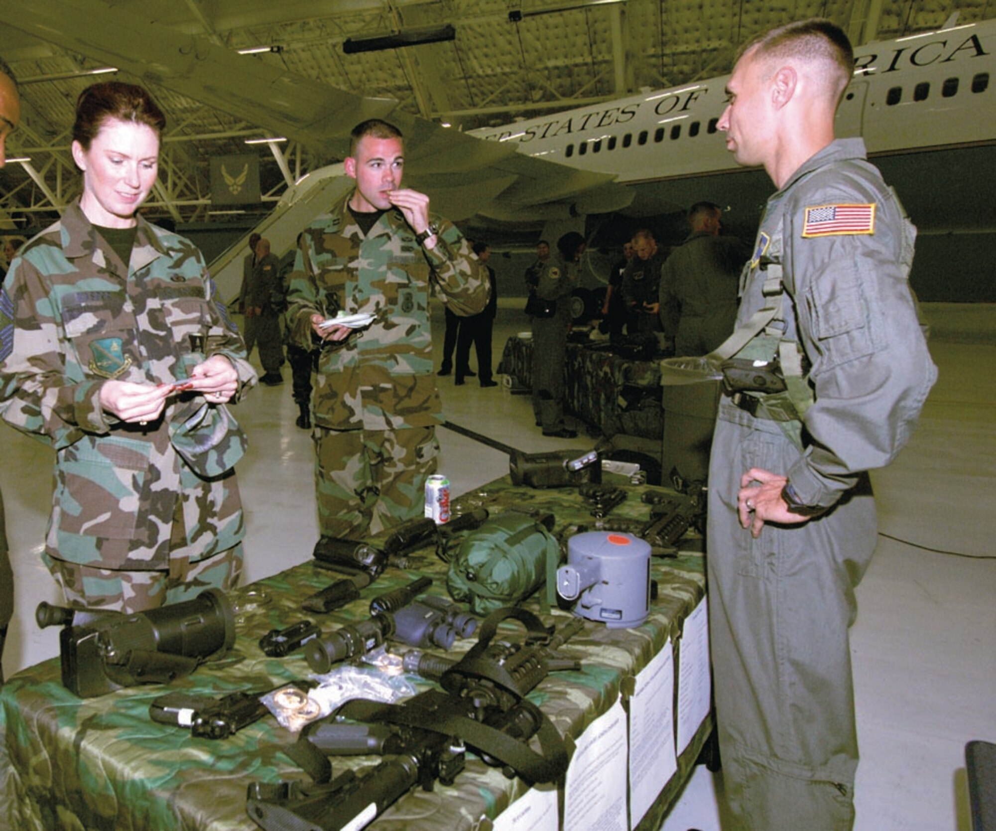 Tech. Sgt. Will Lemaser, 316th Security Forces Squadron Raven, explains the uses and capabilities of equipment to chief Master Sgt. Robin Kasper, 316 SFS superintendent, during a hands-on demonstration during the Ravens security demonstration inside hangar four on Sept. 25. The Raven Team's mission is to provide security for all special air missions carrying the President, Vice President and other senior government leaders during their official travel. (US Air Force/A1C Renae Kleckner)