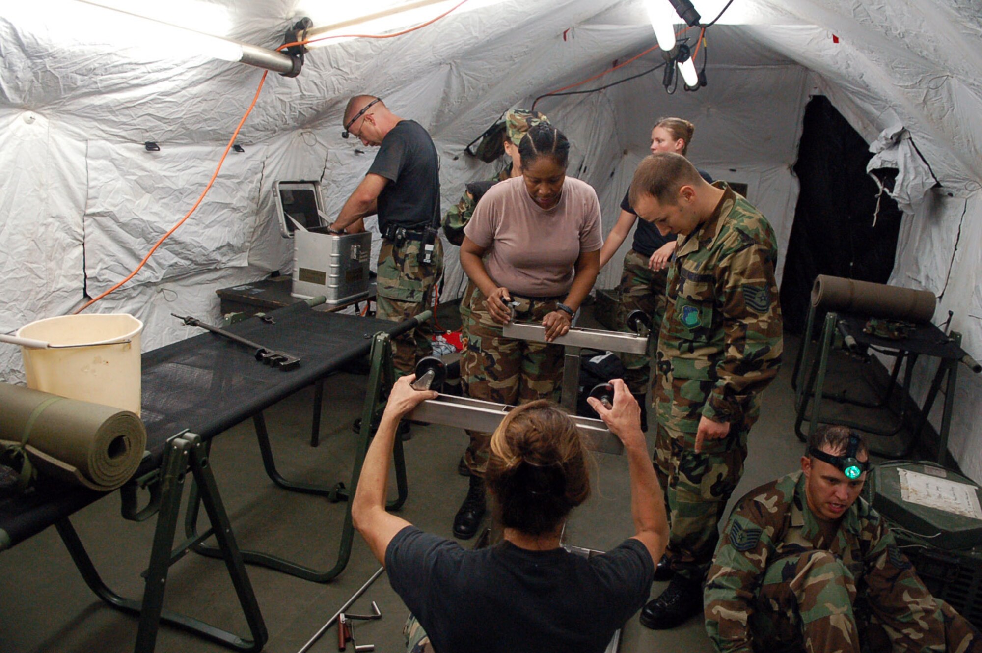 Members of the Joint Task Force-Bravo Medical Element work together to set up a mobile surgical team tent in an empty field at Soto Cano Air Base, Honduras, Oct. 18. The team built the mobile operating room at night to practice setting up in limited visibility. (U.S. Air Force photo/Staff Sgt. Austin May)
