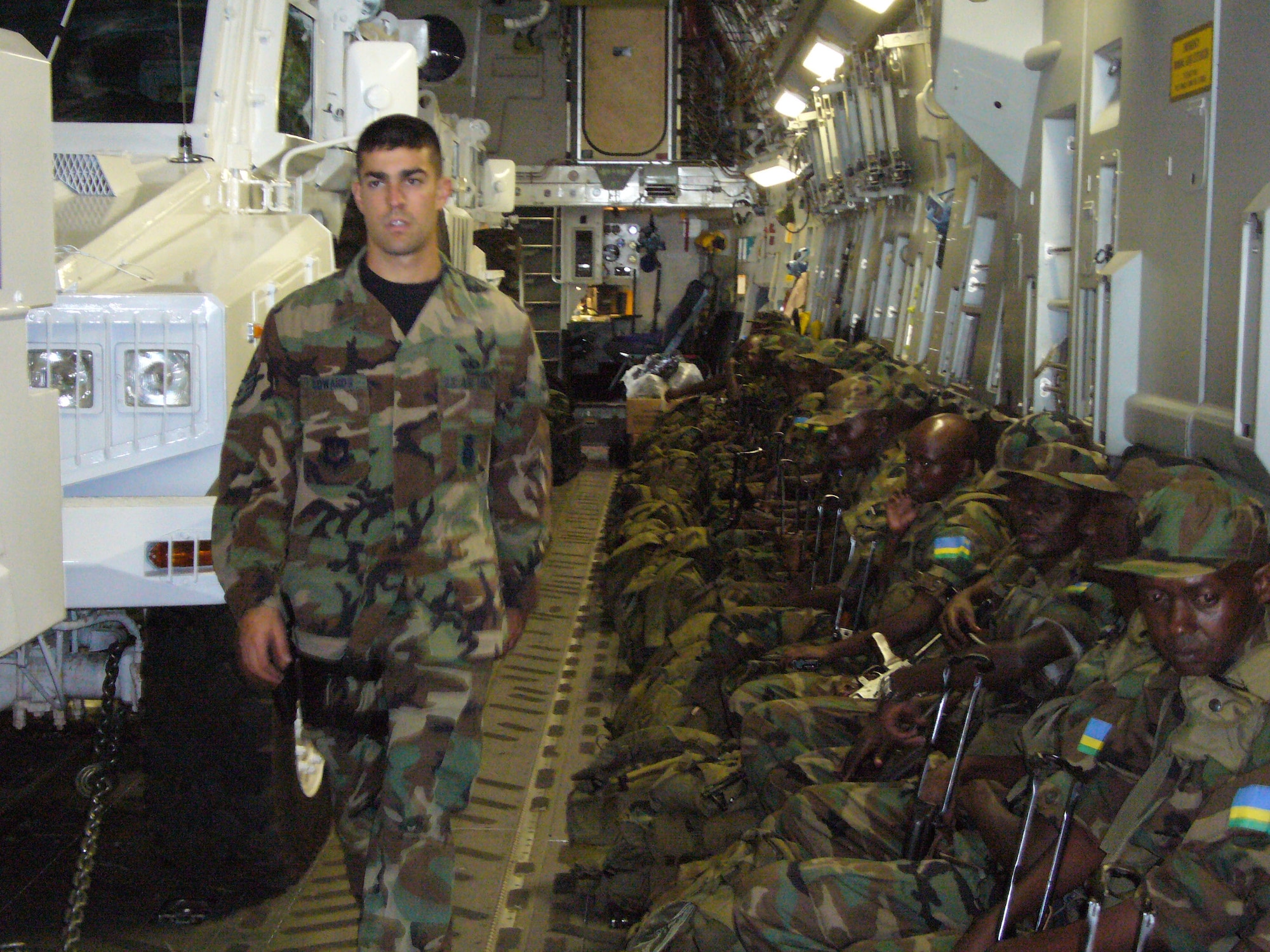 Staff Sgt.Dave Edwards, 786th Air Expeditionary Squadron Security Forces, checks the Rwandan Soldiers onto the C-17 Globemaster en route to the Darfur region of Sudan Oct. 24 at Kigali International Airport in Kigali, Rwanda .  (U.S. Air Force photo by Capt Erin Dorrance)
