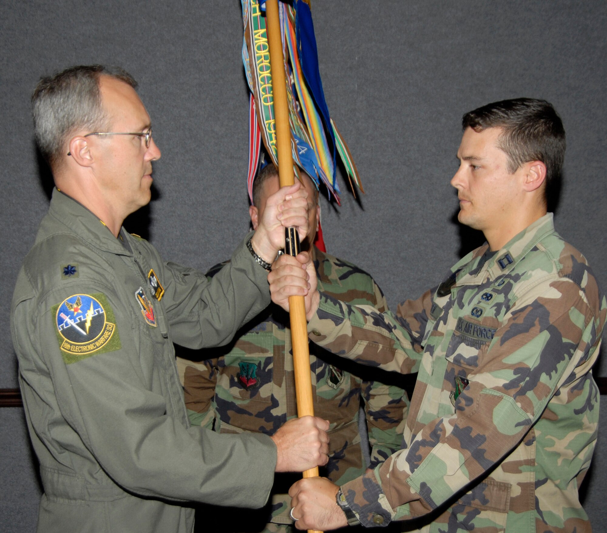 Capt. Blair Byrem, 16th Electronic Warfare Squadron Det. 1 commander, accepts the guidon from Lt. Col. Dean King, 16th EWS commander, signifying the activation of the detachment. The detachment was previously only an operating location for the 16th EWS. The location became a detachment as of Oct. 1.  Air Force photo.