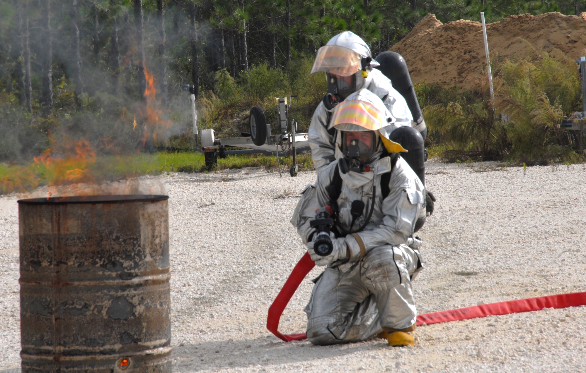 Tyndall Air Force Base firefighters battle a controlled and simulated F-15 crash site during an exercise in Mexico Beach, Fla. Oct. 23.  Also on scene were first responders from Mexico Beach and Port St. Joe, Fla. (U.S. Air Force photo/Susan Trahan)