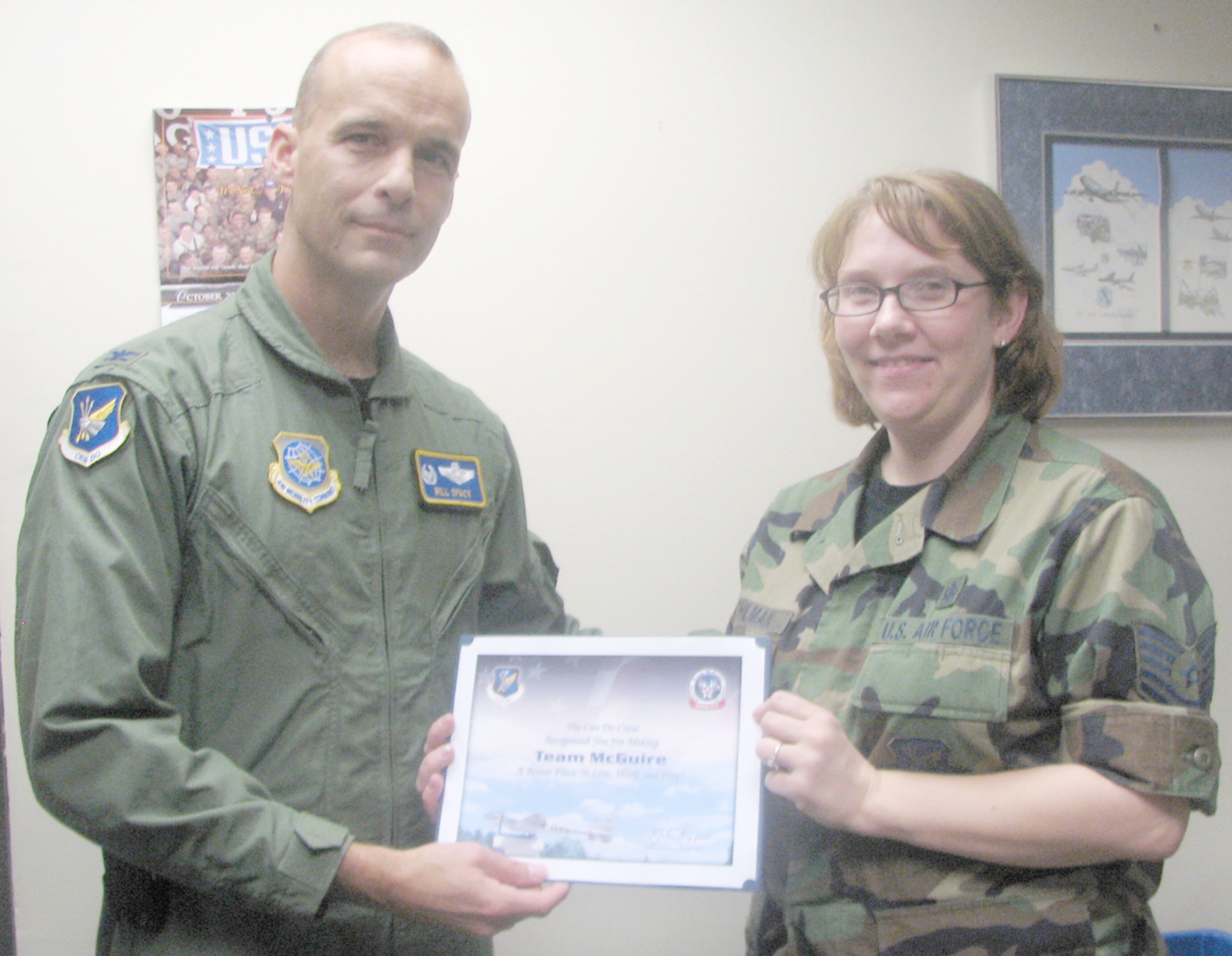 Col. Bill Spacy, 305th Air Mobility Wing vice commander, recognizes Tech. Sgt. Chyrle Wohlman of the 305th AMW Protocol Office with a Can Do award. The Can Do Crew seeks and recognizes outstanding Team McGuire members.