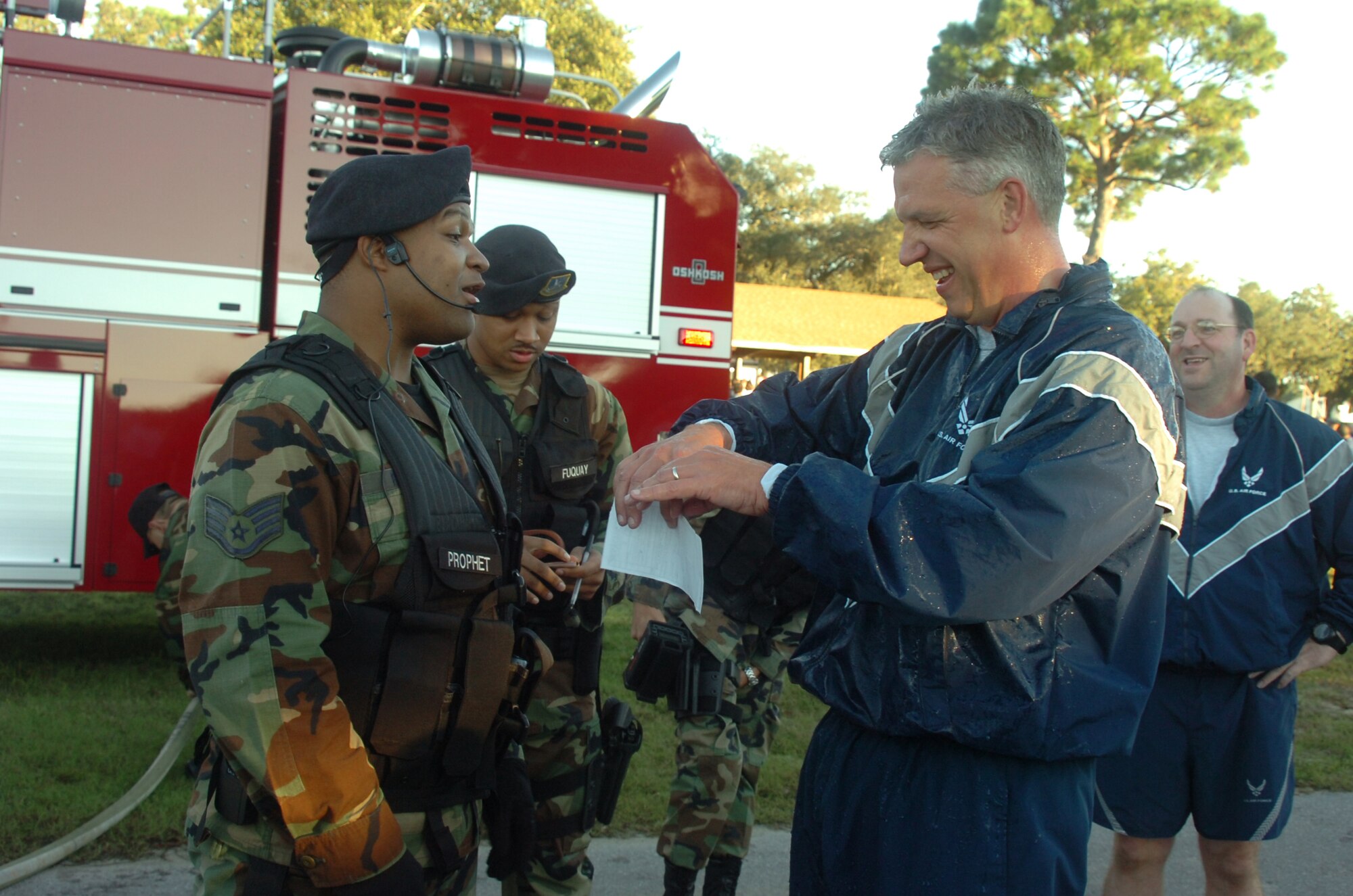 EGLIN AIR FORCE BASE, Fla. -- Col. Dean Clemons, 96th Air Base Wing commander, tears up a ticket given to him by security forces during his final wing run.  Colonel Clemons is departing for a year-long deployment in Iraq. (U.S. Air Force photo by Staff Sgt. Mike Meares)