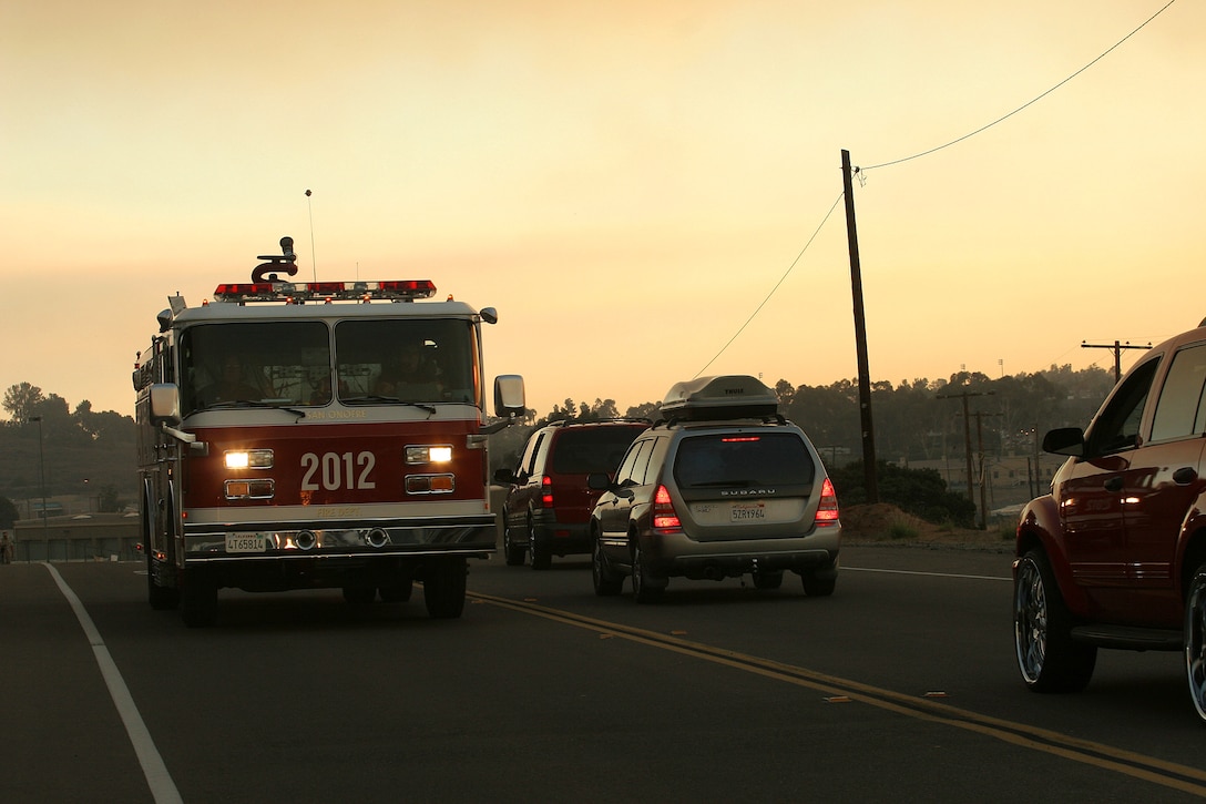 A fire truck heads towards the Fallbrook Gate as it passes a line of cars going to Las Pulgas Gate at Camp Pendleton, Calif., Oct. 22, 2007. Camp Pendleton and the Naval Weapons Station opened their gates from Fallbrook to Las Pulgas for wild fire evacuees heading onto Interstate 5 North.
