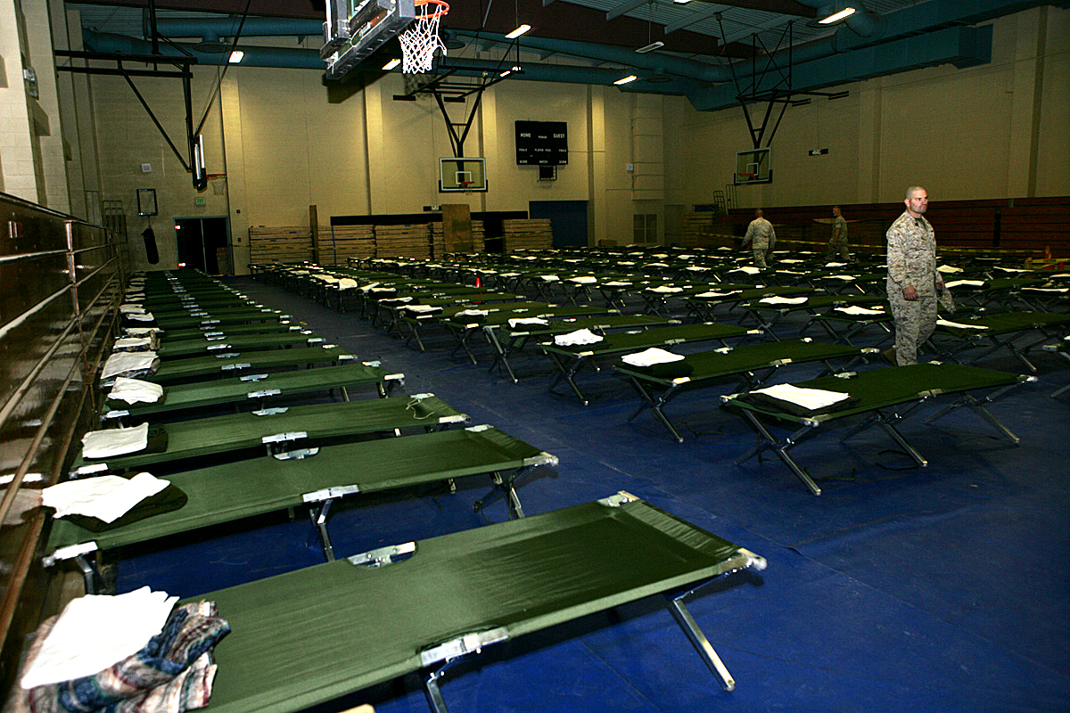 Marines and Sailors with Regimental Combat Team 5 (RCT5) set up cots