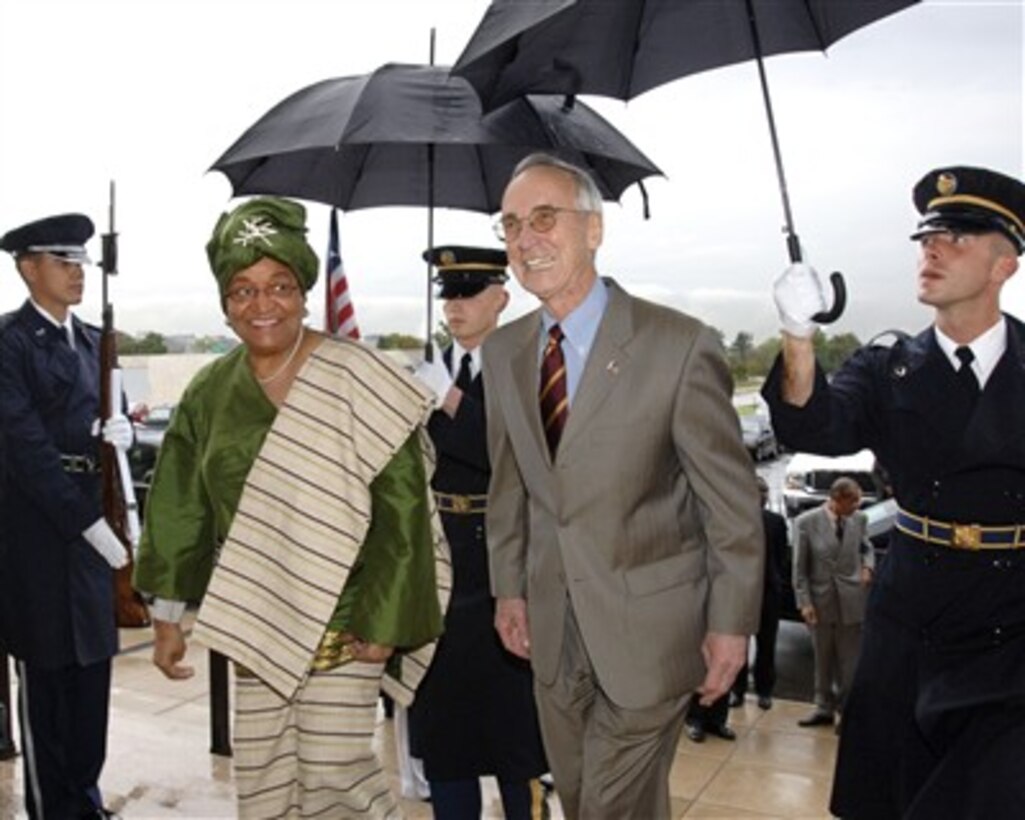 Deputy Secretary of Defense Gordon England (2nd from right) escorts Liberian President Ellen Johnson-Sirleaf through an honor cordon and into the Pentagon for discussions on a broad range of bilateral security issues on Oct. 24, 2007.  