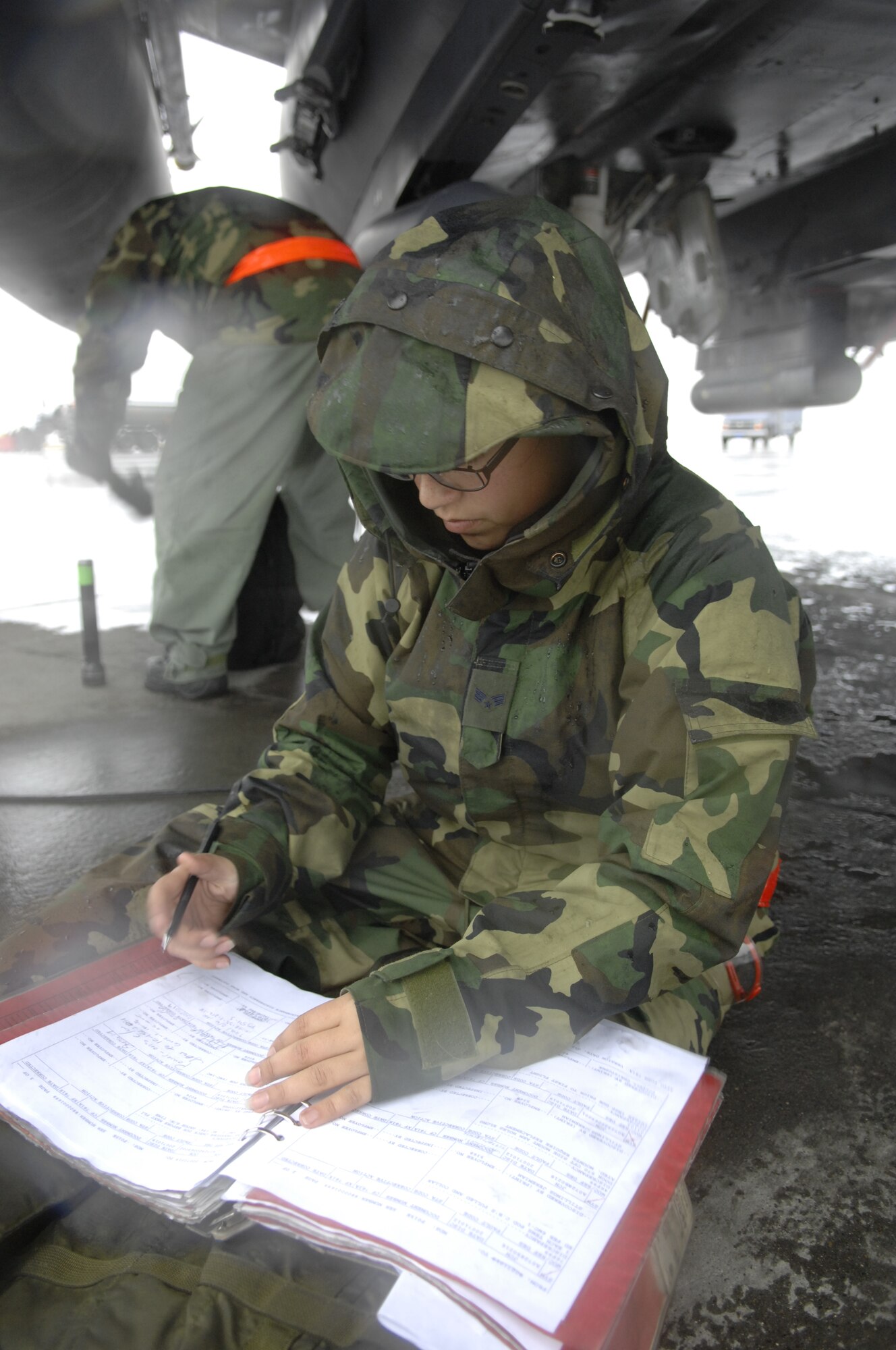 MOUNTAIN HOME AIR FORCE BASE, Idaho -- Senior Airman Jennifer Musgrove, 366th Aircraft Maintenance Squadron, completes the check list after completing maintenance on an F-15 E in preparation for an engine run during the bases operational readiness exercise Oct 19. The 366th Fighter Wing is participating in Operational Readiness Exercise Sharpshooter 08-01 in preparation for the upcoming operational readiness inspection in March 2008. (U.S. Air Force photo/ Airman 1st Class Dana D. Hill)