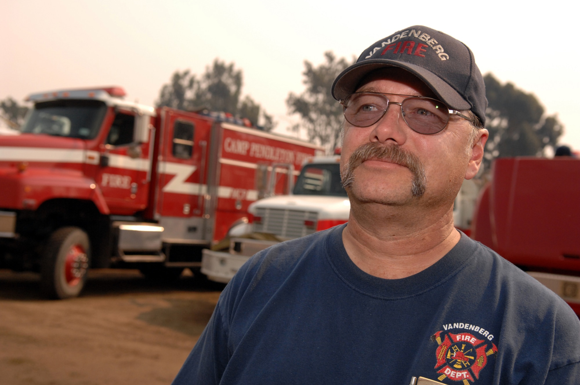 Tim Murdoch observes the base camp Oct. 25 at Camp Pendleton, Calif. Mr. Murdoch, an engineer from Vandenberg Air Force Base, Calif., has been assigned to the base camp as the camp manager. Vandenberg AFB currently has 12 firefighters dispatched throughout Southern California in support of more than 26 fires that have burned more than 1,800 homes and 550,000 acres. (U.S. Air Force photo/Staff Sgt. Vanessa Valentine)