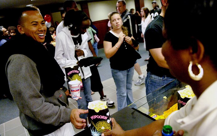 Airman 1st Class Allen Calais, 437th Medical Group, public health technician, gets free soda and popcorn from the concession stand at the newly renovated base theater Wednesday night on Charleston AFB. The theater just opened after being closed for two years. (U.S. Air Force photo/Airman 1st Class Nicholas Pilch)