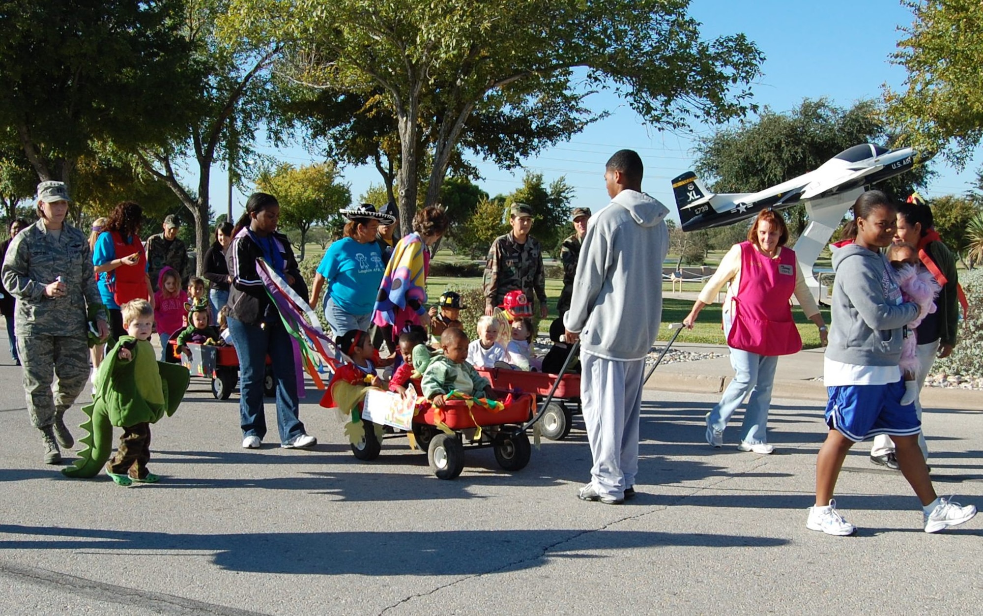 Laughlin Air Force Base members walk around the Ribas-Dominicci Circle towards the end of the Child Development Center's annual Halloween Parade.  Throughout the month, the children listened to stories and were then asked to come dressed as their favorite character for a parade. Costumes ranged from dinosaurs to princesses and other creative outfits. (U.S. Air Force photo/2nd Lt. Megan Togni)