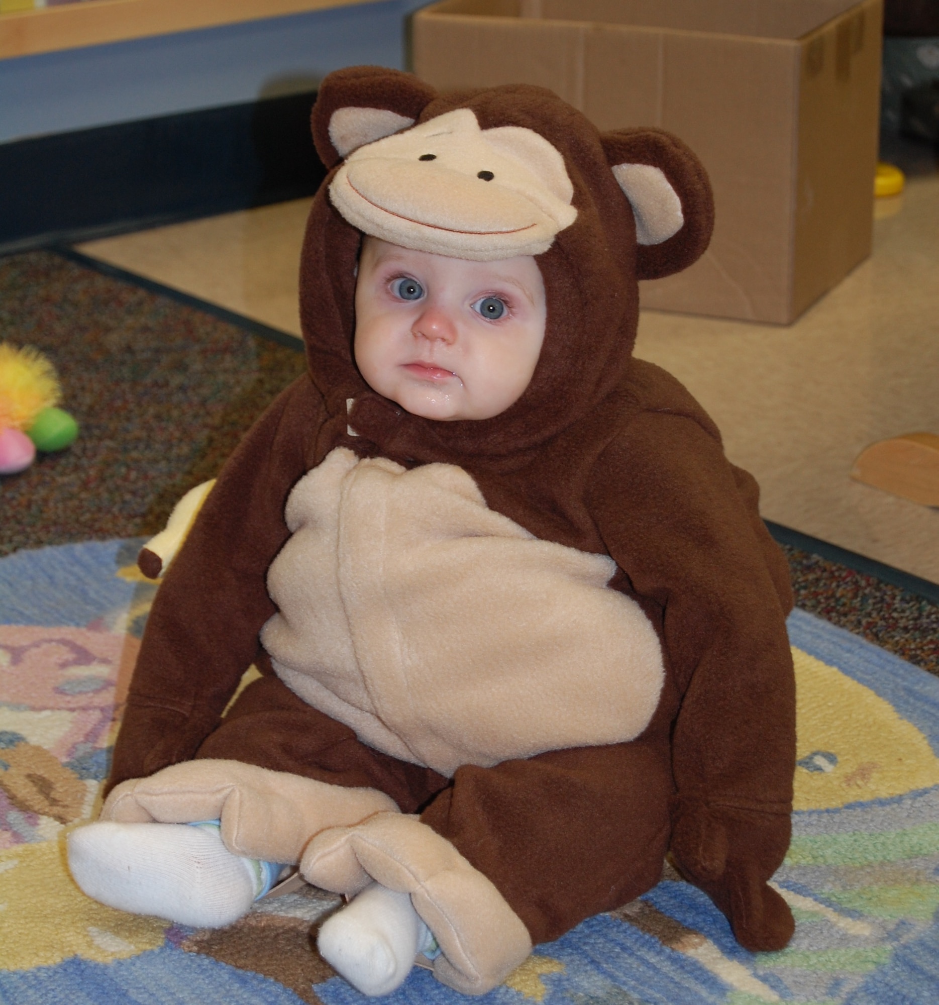 Kyle Ficzner, son of Senior Airman Brain Ficzner of the 47th Civil Engineer Squadron, waits patiently to be taken out of his monkey costume after the Halloween Parade held Oct. 26, 2007.  Throughout the month, the children listened to stories and were then asked to come dressed as their favorite character for a parade. Costumes ranged from dinosaurs to princesses and other creative outfits. (U.S. Air Force photo/2nd Lt. Megan Togni)