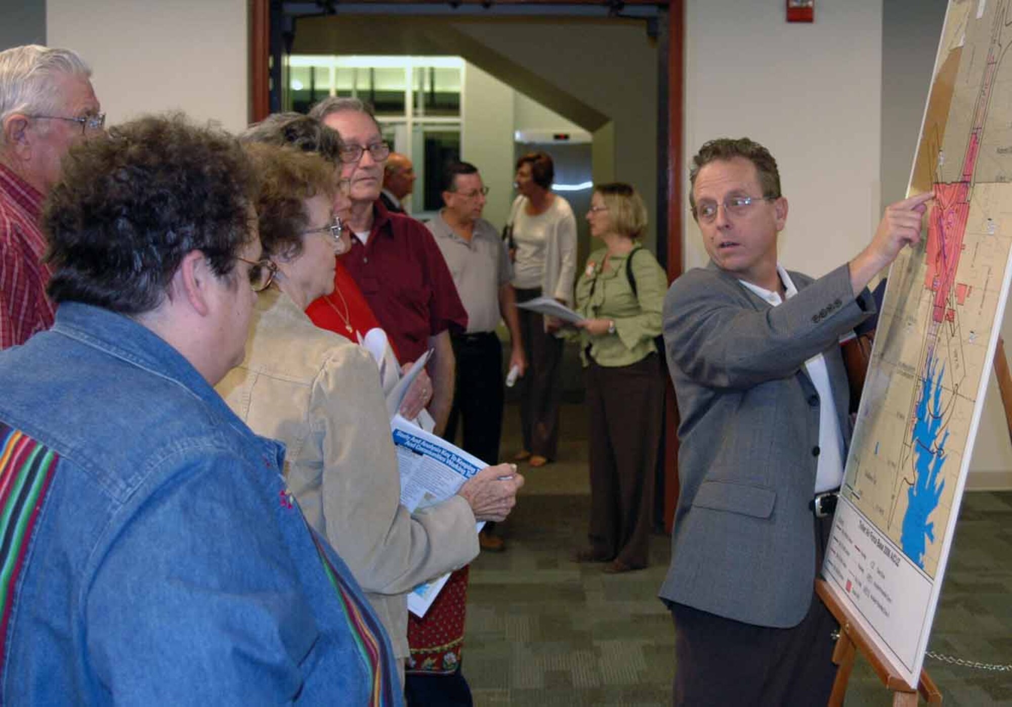 Tinker environmental spokesman Brion Ockenfels discusses an Air Installation Compatible Use Zone map to some of the area residents attending the Joint Land Use Study town meeting Oct. 18 in Midwest City. (Air Force photo by Ralph Monson)

