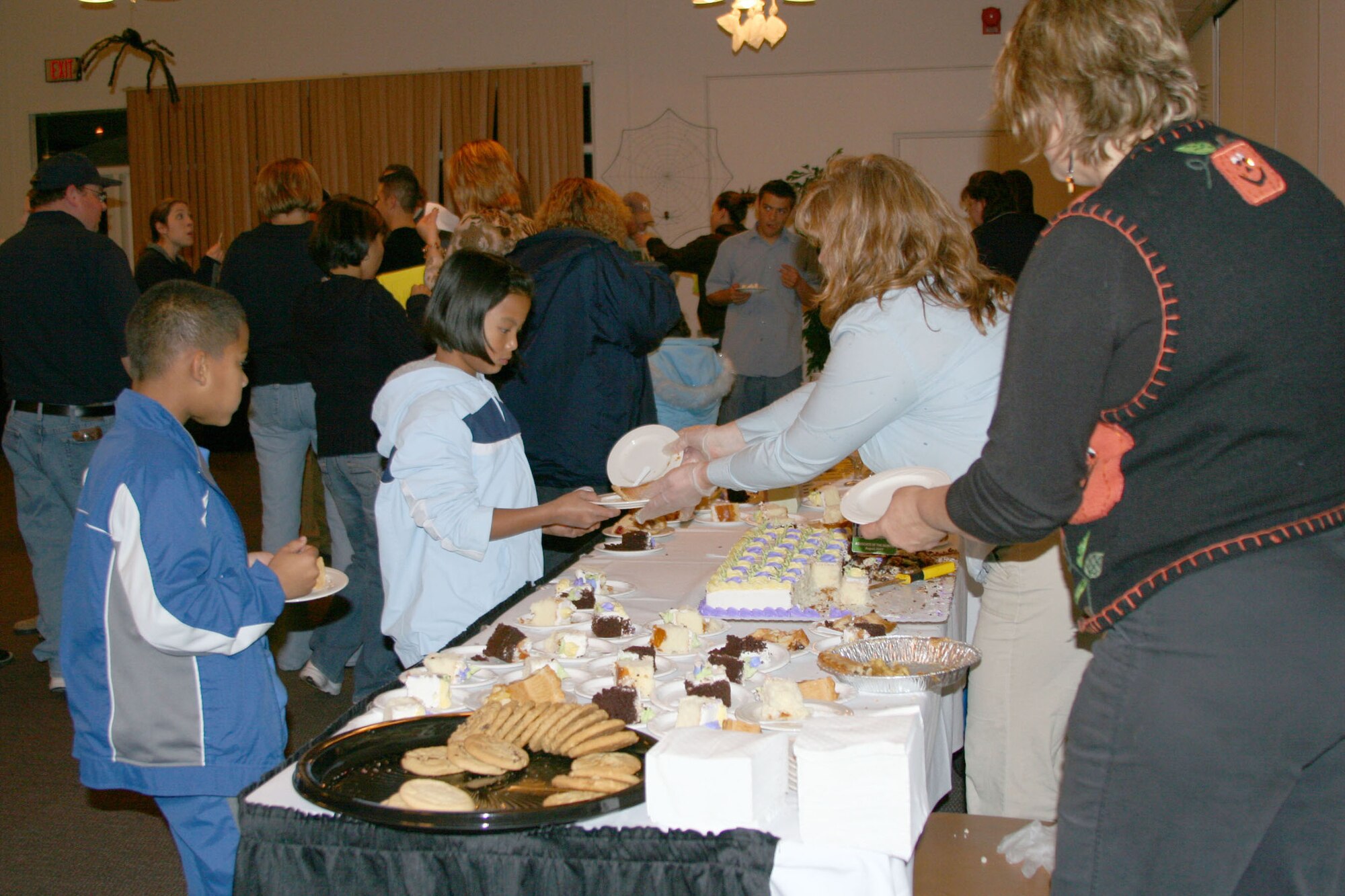 Little Warriors Adnan, 10, and Roselyn, 9, check out a table full of desserts and holiday-themed treats at the 341st Services Squadron's Ski and Dessert Expo at the Grizzly Bend Club Oct. 25. State-wide ski resort representatives were on hand to talk about downhill and cross-country ski trails, lodging and equipment. There was also a wide-variety of desserts to sample and wines to taste, as well as raffle giveaways throughout the evening. (U.S. Air Force photo/Senior Airman Eydie Sakura)