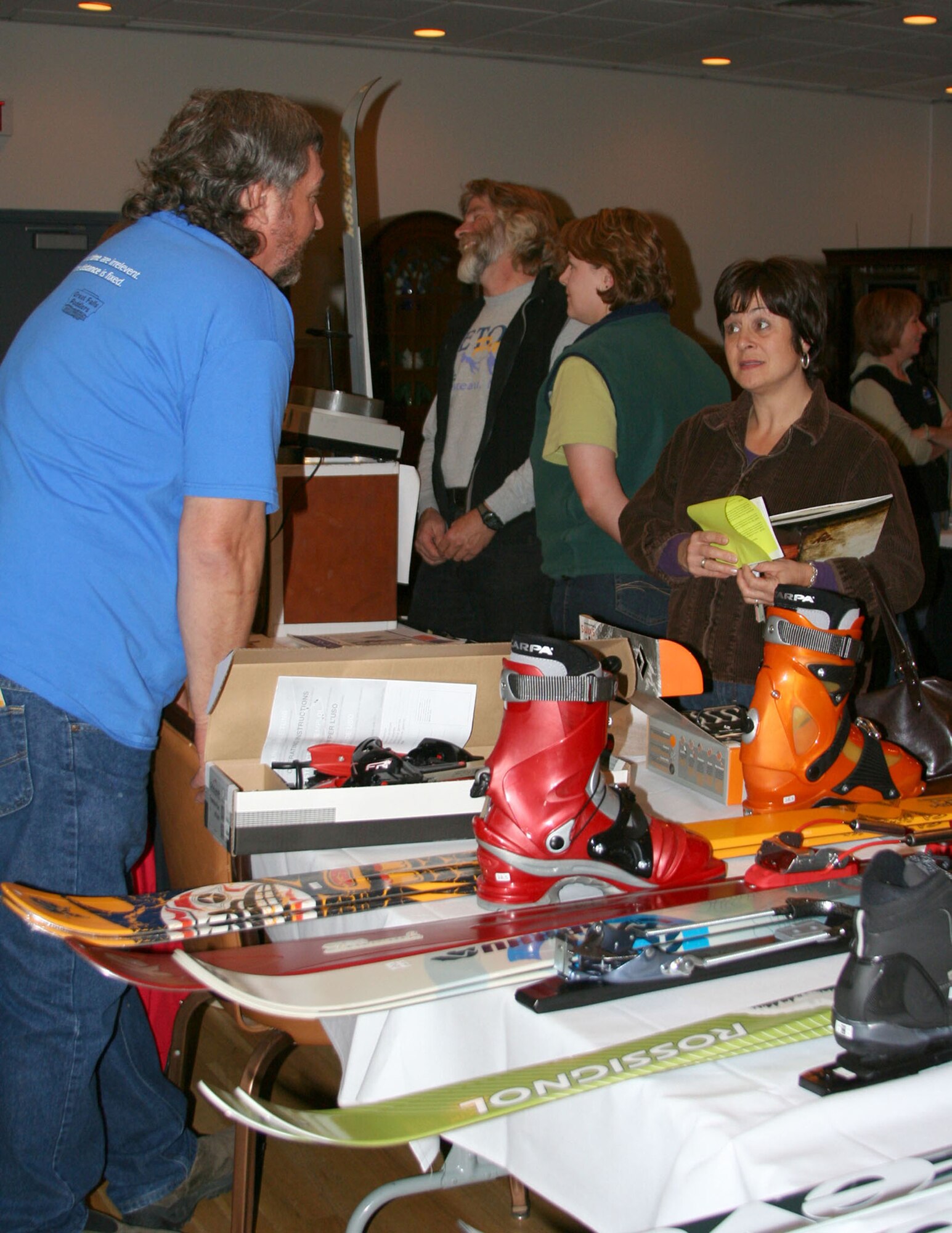 Toni Flack, right, asks questions about local ski trails and ski equipment to Chuck Kohut, Great Falls Cross-Country Ski Club, left, at the 341st Services Squadron's Ski and Dessert Expo at the Grizzly Bend Club Oct. 25. State-wide ski resort representatives were on hand to talk about downhill and cross-country ski trails, lodging and equipment. There was also a wide-variety of desserts to sample and wines to taste, as well as raffle giveaways throughout the evening. (U.S. Air Force photo/Senior Airman Eydie Sakura)