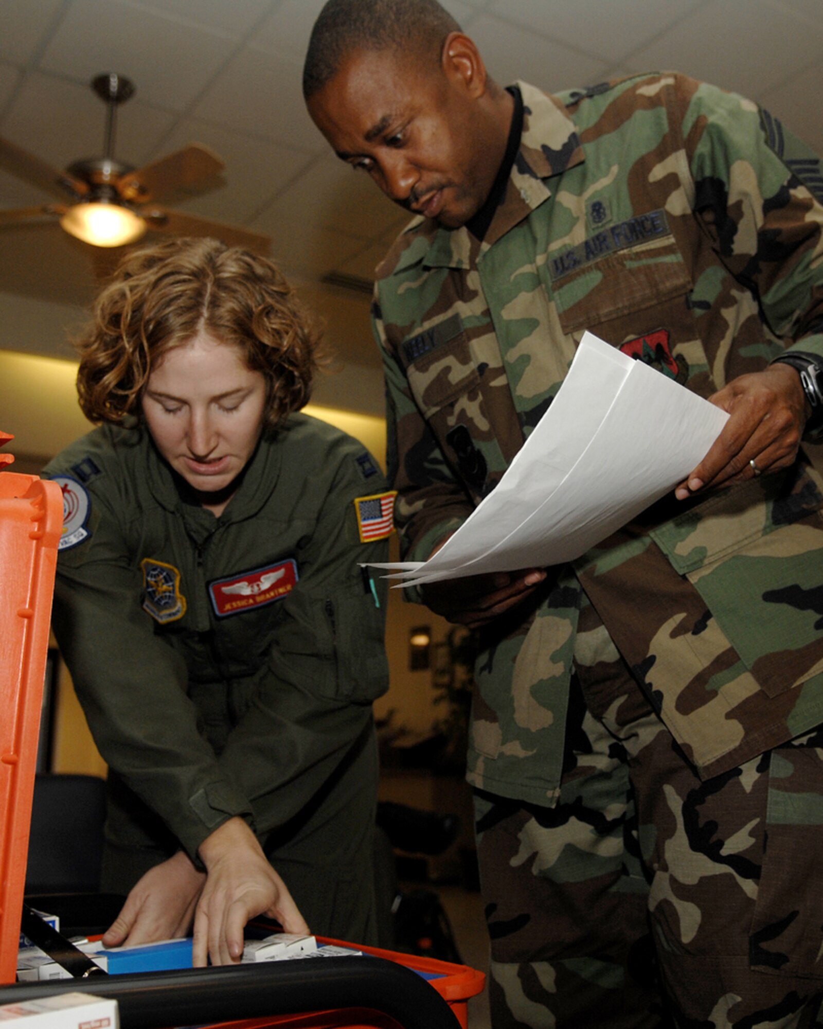 Capt. Jessica Brantner, 375th Aeromedical Evacuation Squadron staff nurse, and Senior Master Sgt. Marvin Neely, 375th AES superintendent, go over inventory of medical supplies prior to a C-17 flight to March Air Force Base, Calif. Wednesday.  In total, seven Airmen from the 375th AES, including four officers and four enlisted, deployed to Southern California to provide medical support to wildfire victims. 
