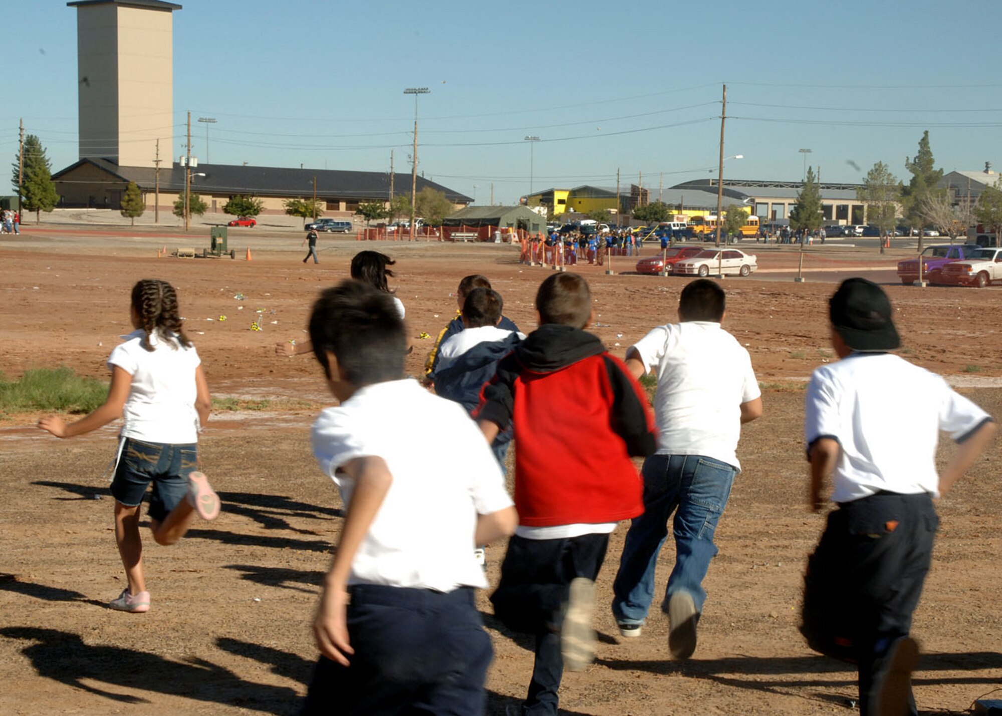 Children from the Desert Bute Elementary School rush to gather parachutes from a rocket launch at Holloman Air Force Base Oct 26, 2007. The children helped countdown the launch of the rocket as a part of the Education Day during Holloman’s Air and Space Expo. The Holloman Air and Space Expo is a showcase of Air Force capabilities, the 49th Fighter Wing mission, and the X Prize Foundation.(US Air Force photo by Airman First Class Tiffany AM Trojca)