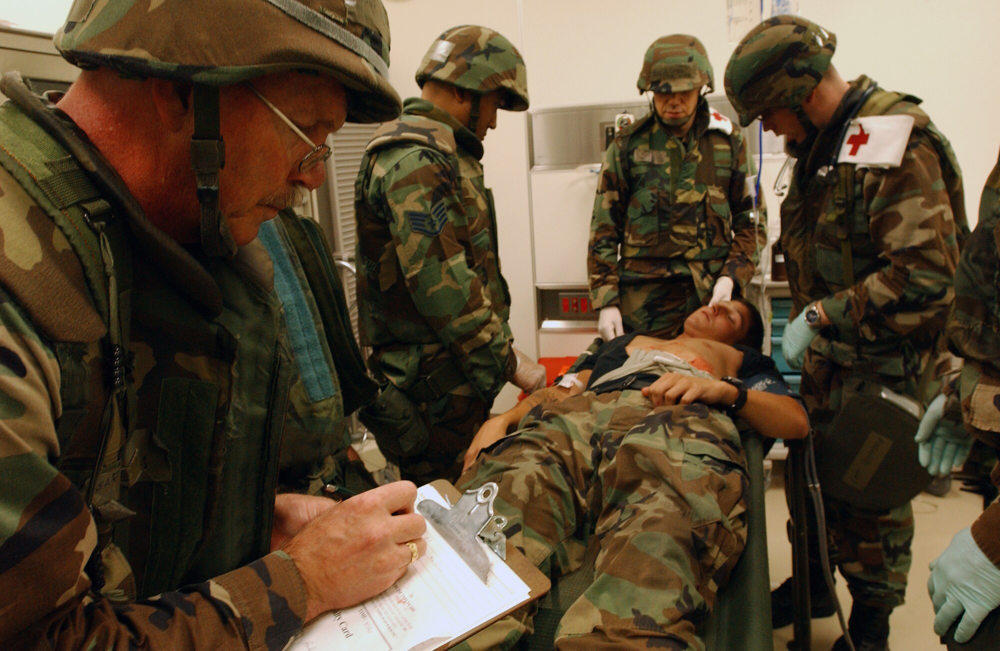 Lt. Col. Pete Sorenson writes down the conditions of a patient before transporting him to the hospital at Kadena Air Base, Japan, Oct. 24. The mass casualty scenario helped Airmen train on treating wounds and applying basic life-saving steps during the Local Operational Readiness Exercise Beverly High 08-1. Colonel Sorenson is assigned to the 18th Medical Group. (U.S. Air Force photo/Tech. Sgt. Rey Ramon) 