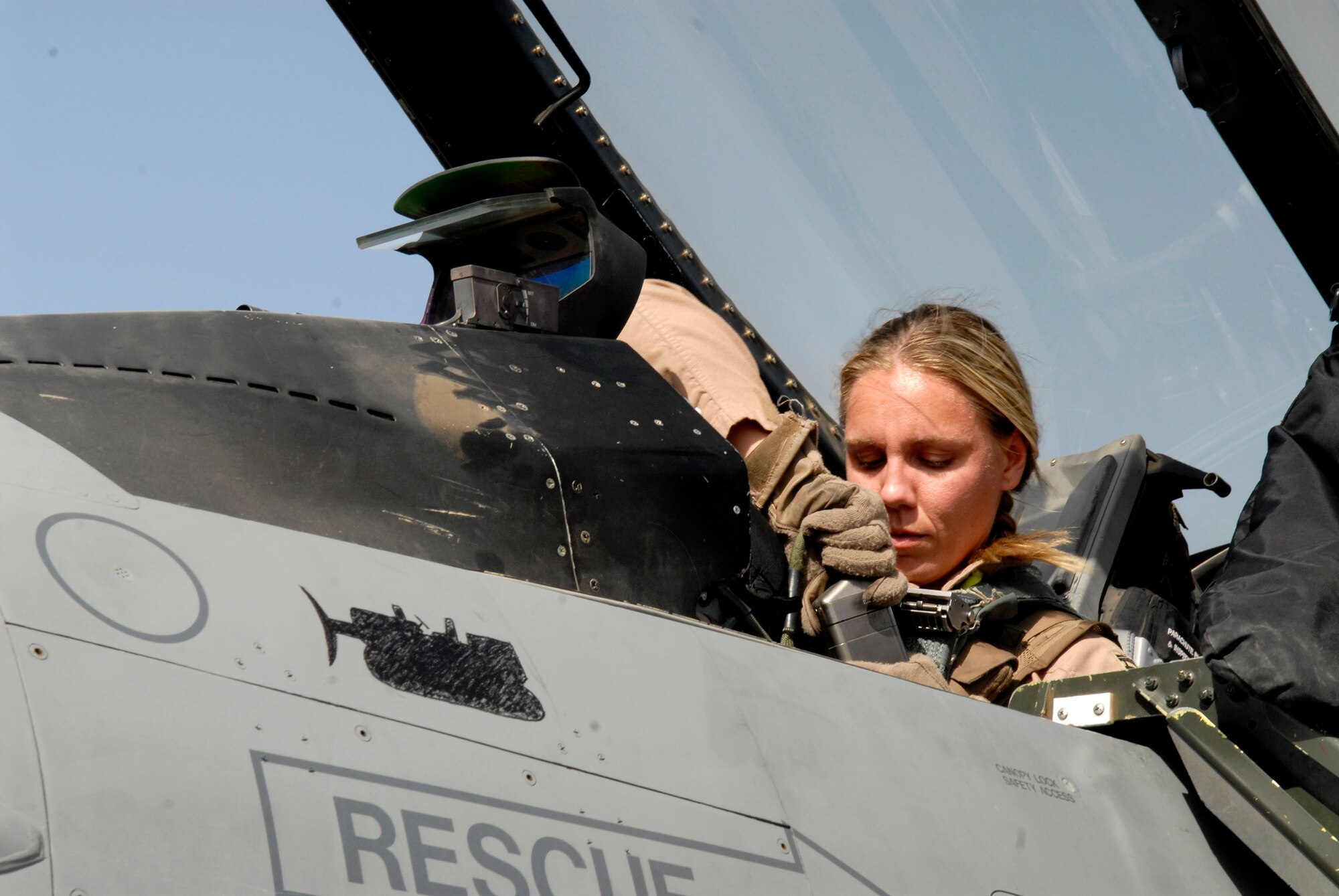 Capt. Caroline Jensen connects the communications receiver to her helmet ensuring she is in contact with personnel on the ground before taking off in an F-16 Fighting Falcon from Balad Air Base, Iraq. Captain Jensen is assigned to the 4th Expeditionary Fighter Squadron and is deployed from Hill Air Force Base, Utah. (U.S. Air Force photo/Staff Sgt. Joshua Garcia)