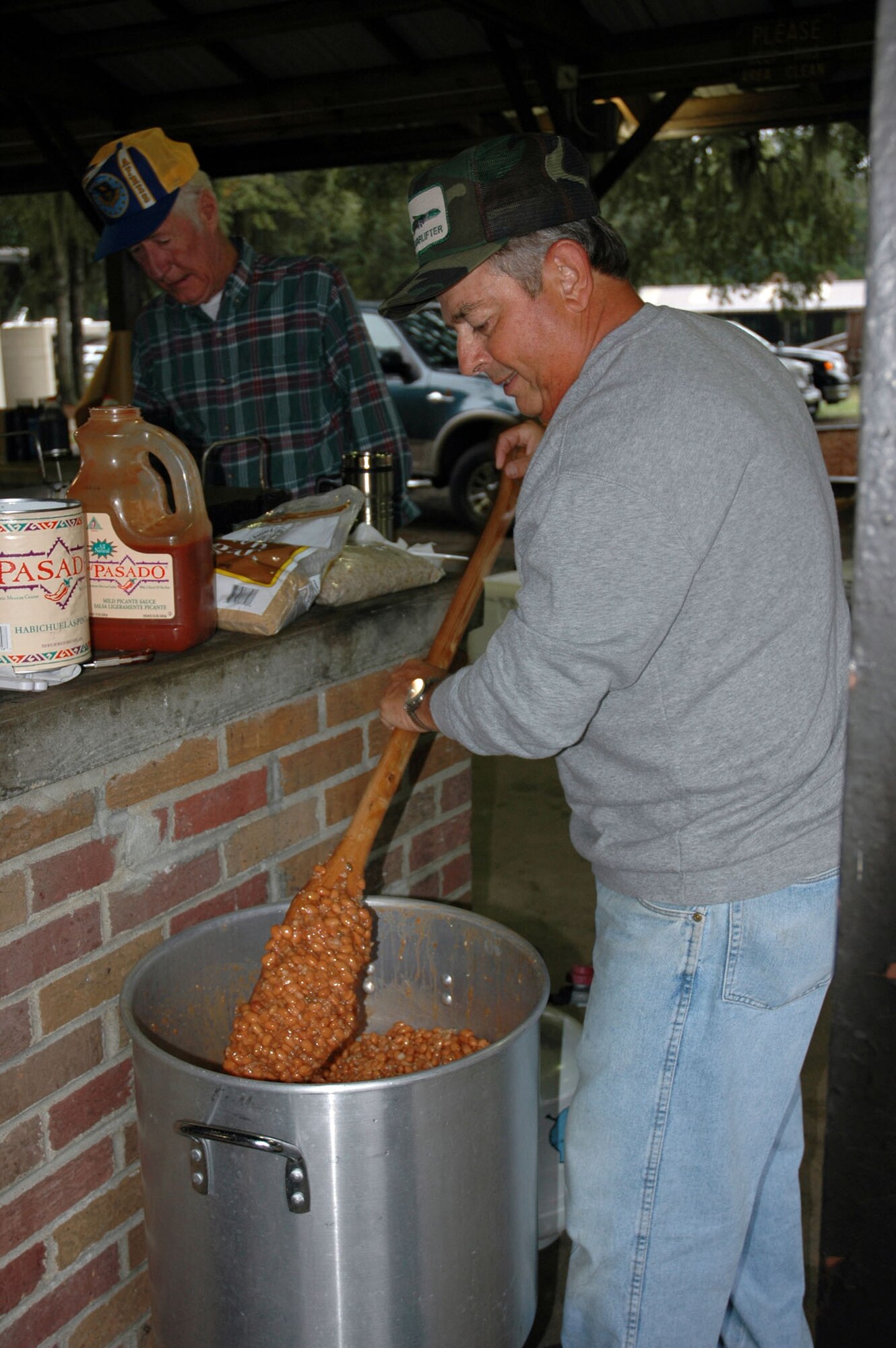 Chief Master Sgt. (retired) Dick Fuller prepares the baked beans for the Charleston Chiefs group fish fry held at the base picnic grounds. (Photo by Debra Baldwin)