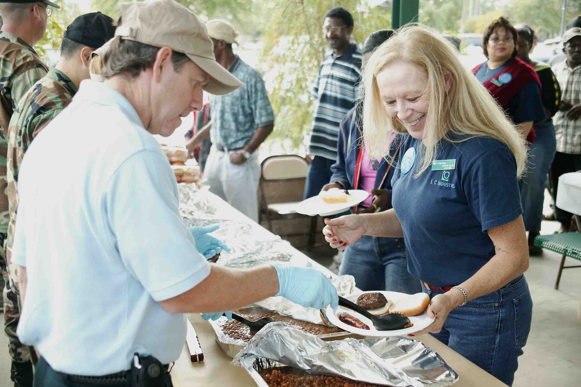 SHAW AIR FORCE BASE, S.C. -- Chris Silva (right), manager of LC Industries, fills up her plate during the annual AbilityOne appreciation picnic Oct. 19. The program provides employment opportunities for people who are blind or have other severe disabilities in the manufacture and delivery of products and services to the federal government. (U.S. Air Force photo/Staff Sgt. John Gordinier)