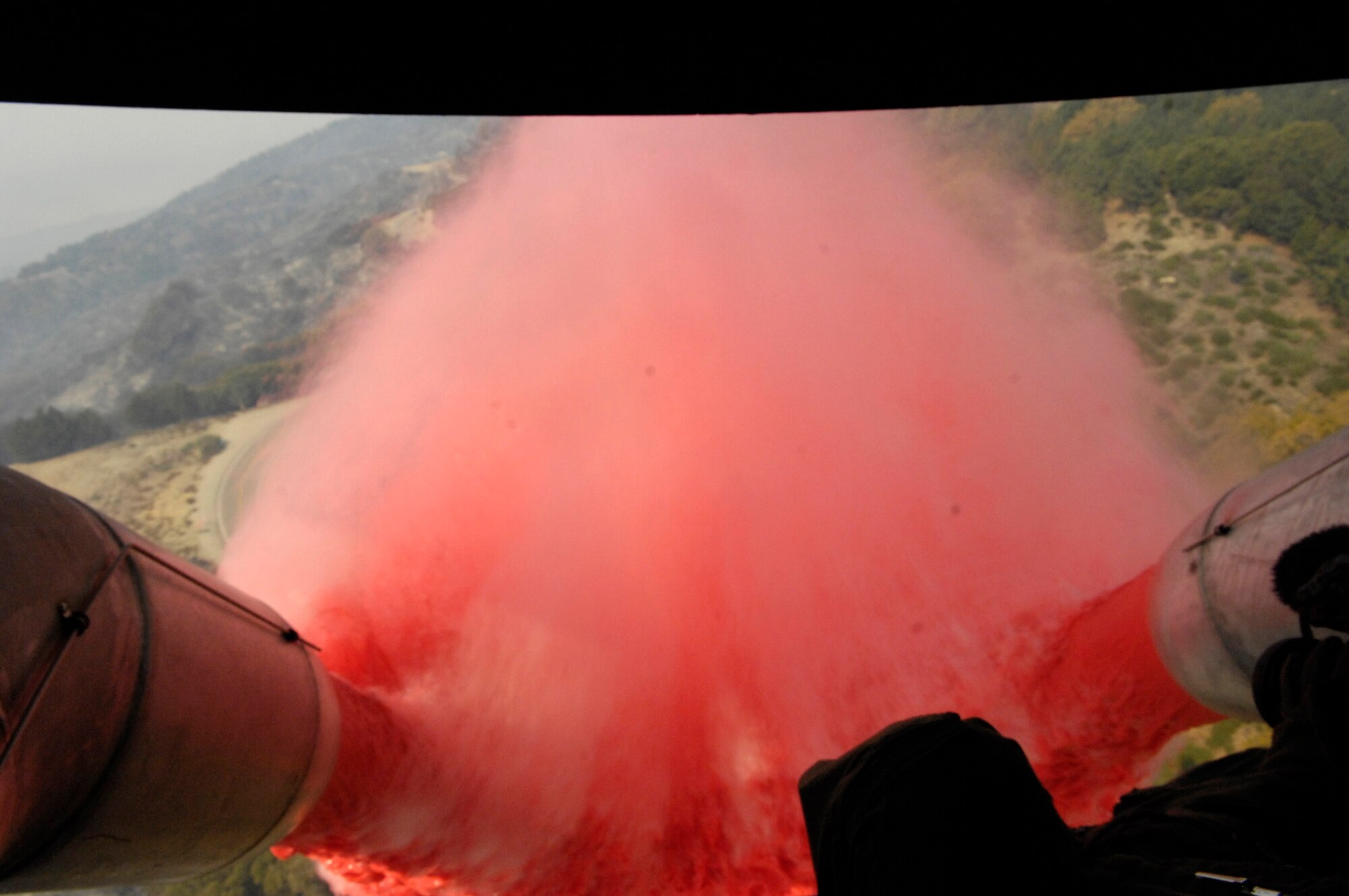 Approximately 3,000 gallons of fire retardant is deployed Oct. 25 over the Poomacha fire in North San Diego County, Calif. The C-130 Hercules and crew are assigned to the 302nd Airlift Wing from Peterson Air Force Base, Colo. The aircraft launched from Channel Islands Air National Guard Station, Calif. (U.S. Air Force photo/Tech. Sgt. Roy A. Santana)
