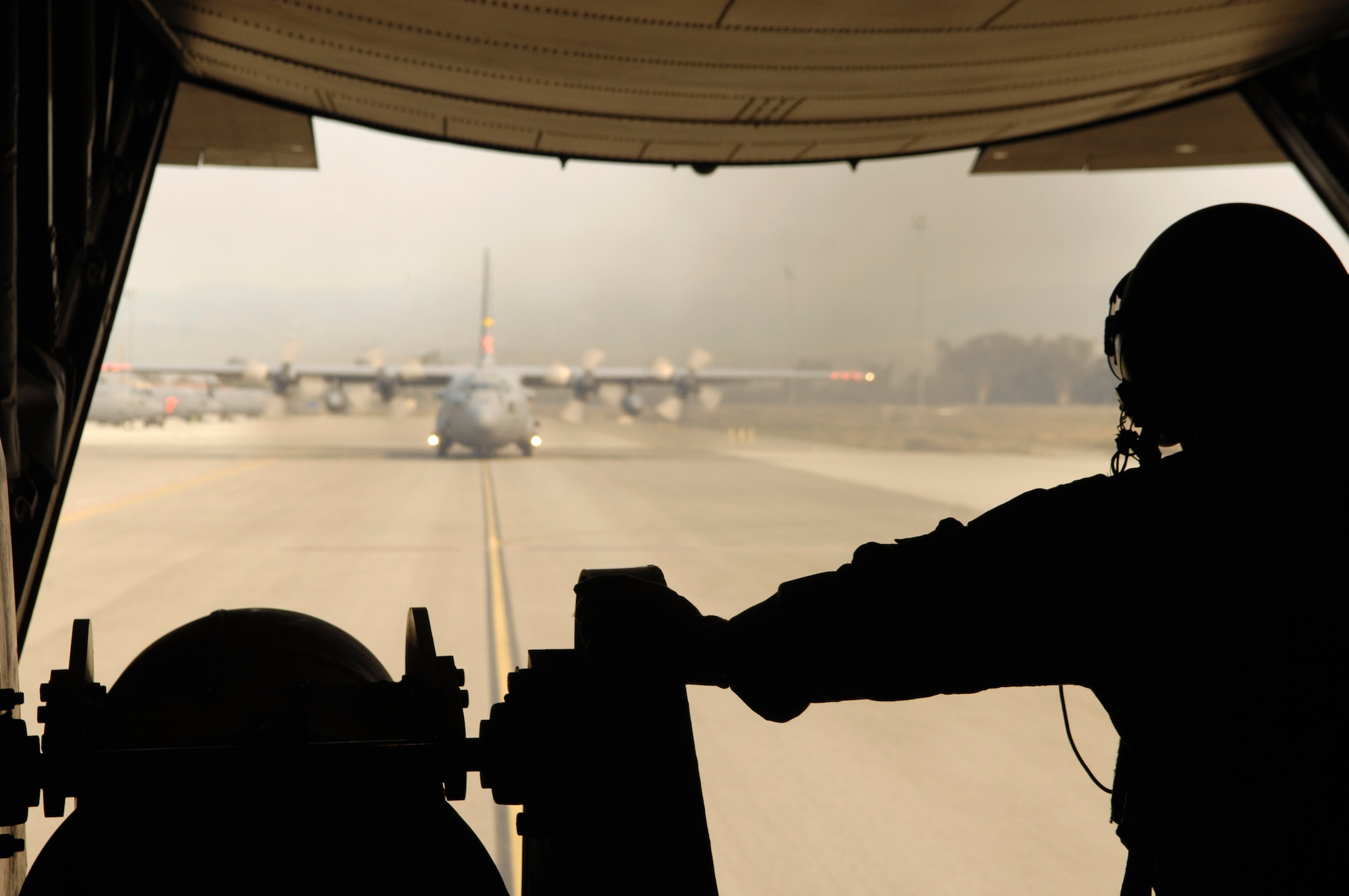 Master Sgt. Thomas Freeman prepares for takeoff on a C-130 Hercules in support of the California firefighting efforts Oct. 25 from Channel Islands Air National Guard Base, Calif. Sergeant Freeman is assigned to the 302nd Airlift Wing from Peterson Air Force Base, Colo. Air Force Reserve Command and Air National Guard Airmen are participating in the Southern California firefighting effort. (U.S. Air Force photo/Tech. Sgt. Roy. A. Santana) 
