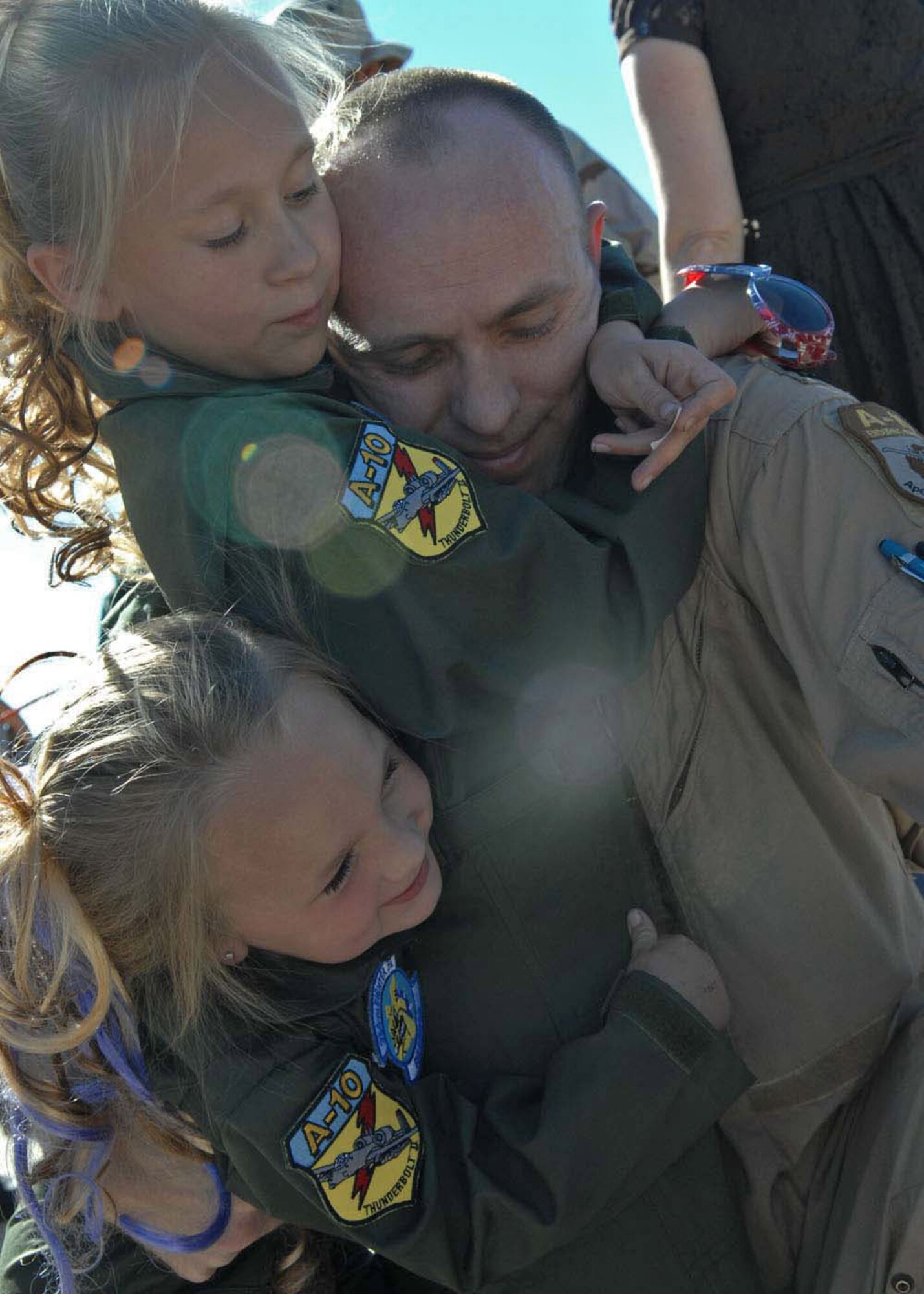 Captain Dennis Hargis is greeted by his daughters, Paige, 7, and Summer, 4, after returning home Oct. 23 from a deployment to Afghanistan. Captain Hargis is an A-10 Thunderbolt II pilot assigned to the 354th Fighter Squadron, Davis-Monthan Air Force Base, Ariz. (U.S. Air Force photo/Senior Airman Christina D. Kinsey) 