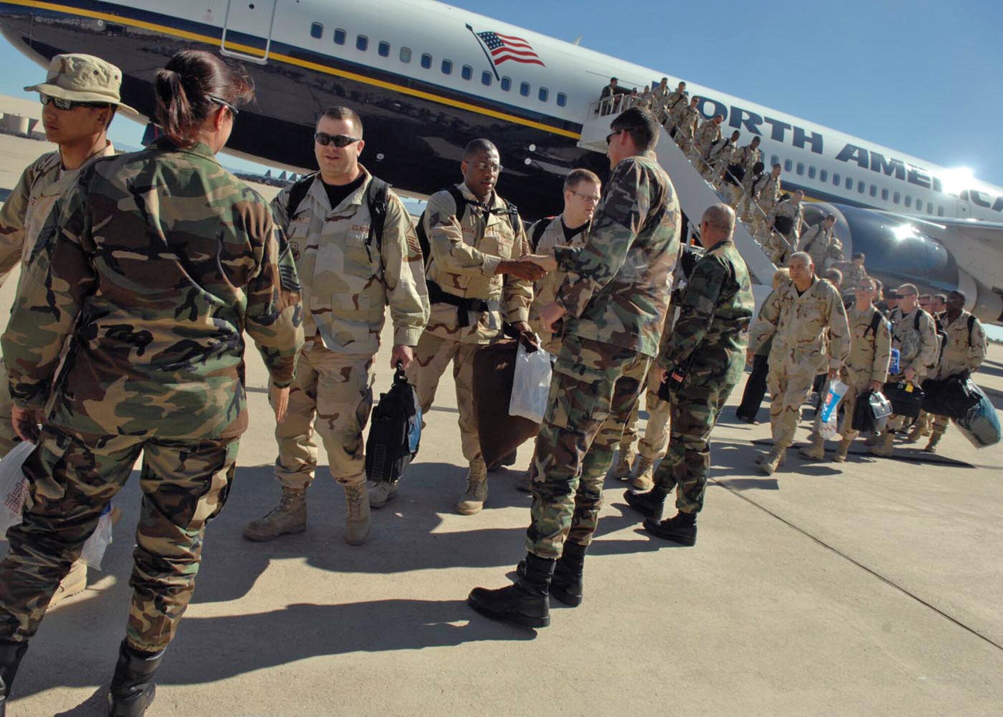 About 200 Airmen from Davis-Monthan Air Force Base, Ariz., return home from Afghanistan Oct. 23 after a seven-month deployment in support of Operation Enduring Freedom. The Airmen were greeted by base leadership and their families after stepping off the plane. (U.S. Air Force photo/Senior Airman Christina D. Kinsey) 