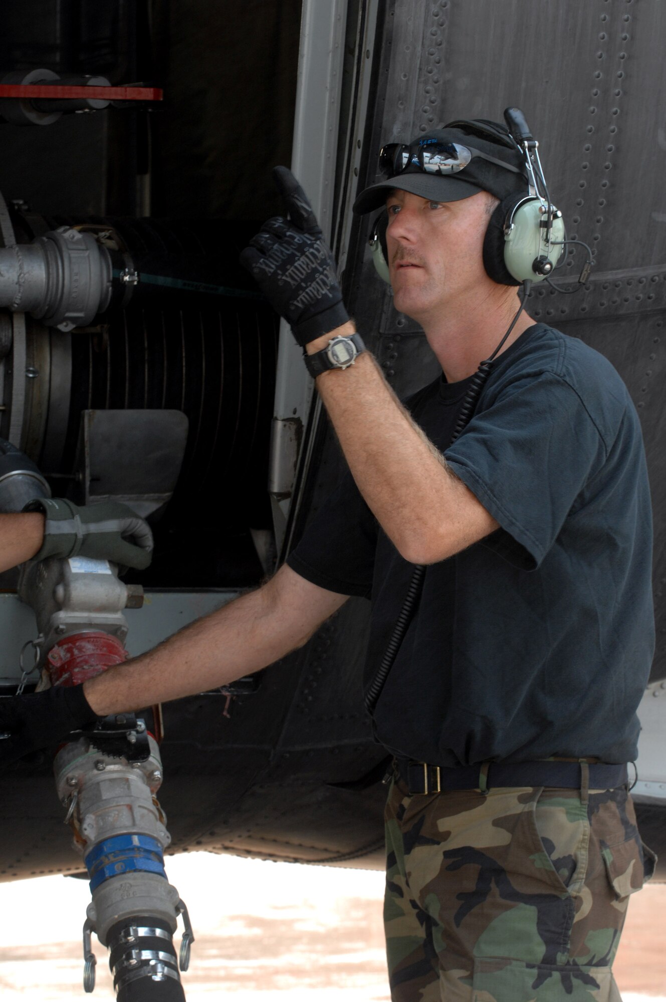 Master Sgt. Mitch Lefler gives the OK to fill the Module Air Fire Fighting System with fire retardant on a C-130 Hercules during a refueling stop Oct. 25 at Channel Islands Air National Guard Base, Calif. Air Force Reserve Command and Air National Guard Airmen are participating in the Southern California firefighting effort. Sergeant Lefler is assigned to the 145th Maintenance Squadron from Charlotte, N.C. (U.S. Air Force photo/Staff Sgt. Hector Garcia)
