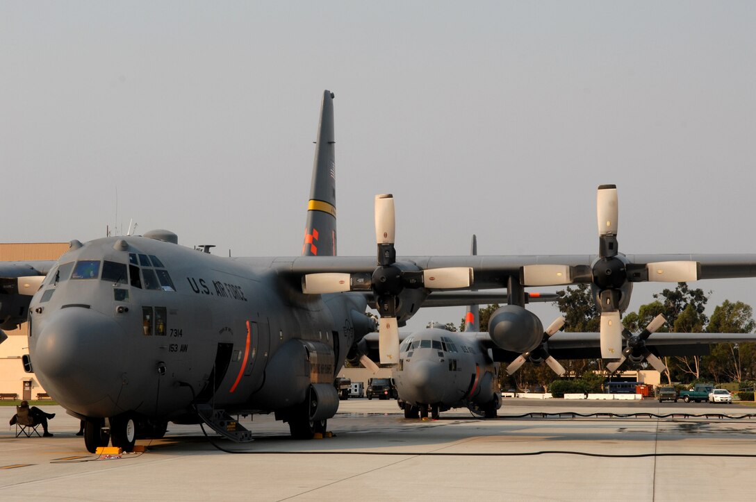 A pair of C-130 Hercules aircraft await deployment to support the California firefighting efforts Oct. 25 at Channel Islands Air National Guard Base, Calif. Air Force Reserve Command and Air National Guard Airmen are participating in the Southern California firefighting effort. (U.S. Air Force photo/Staff Sgt. Hector Garcia)

