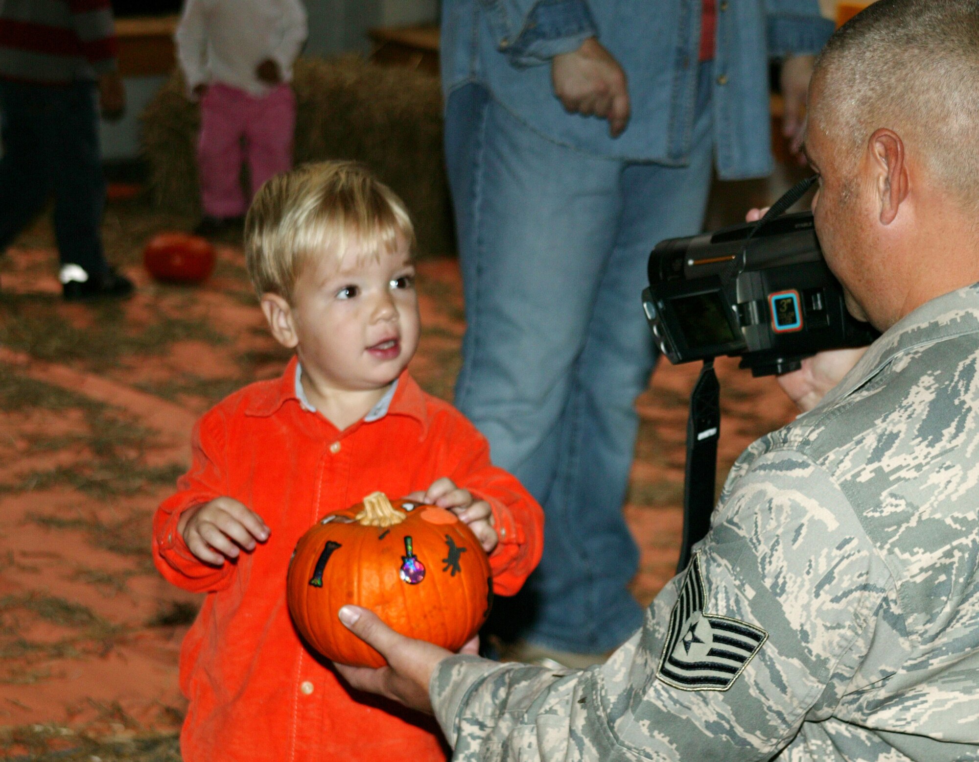 SHAW AIR FORCE BASE, S.C. -- Tech. Sgt. Harold Denton, 20th Aerospace Medicine Squadron, films his son Chase at the Shaw CDC Harvest Fest Oct. 25. Chase's mom, Julie, is the deputy director of the Child Development Center. (U.S. Air Force photo/Tech. Sgt. Kevin Williams)