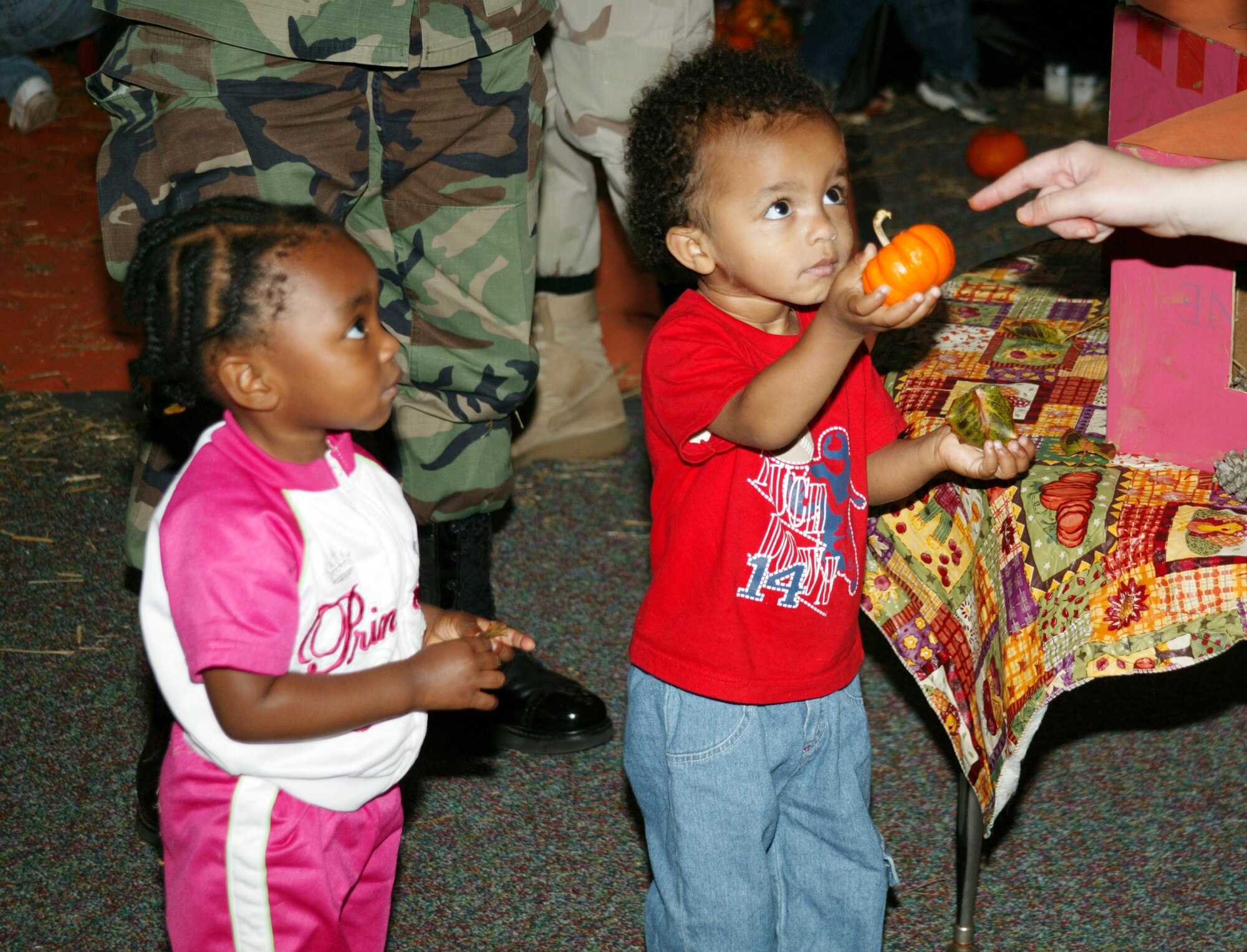 SHAW AIR FORCE BASE, S.C. -- Mitongo Bella-Bella, daughter of William and Maj. Afia Bella-Bella, 9th Air Force, and Anthony Hickmon, son of David and Tech. Sgt. Suzanne Hickmon, 20th Aerospace Medicine Squadron, participate in the Shaw CDC Harvest Fest Oct. 25. (U.S. Air Force photo/Tech. Sgt. Kevin Williams)