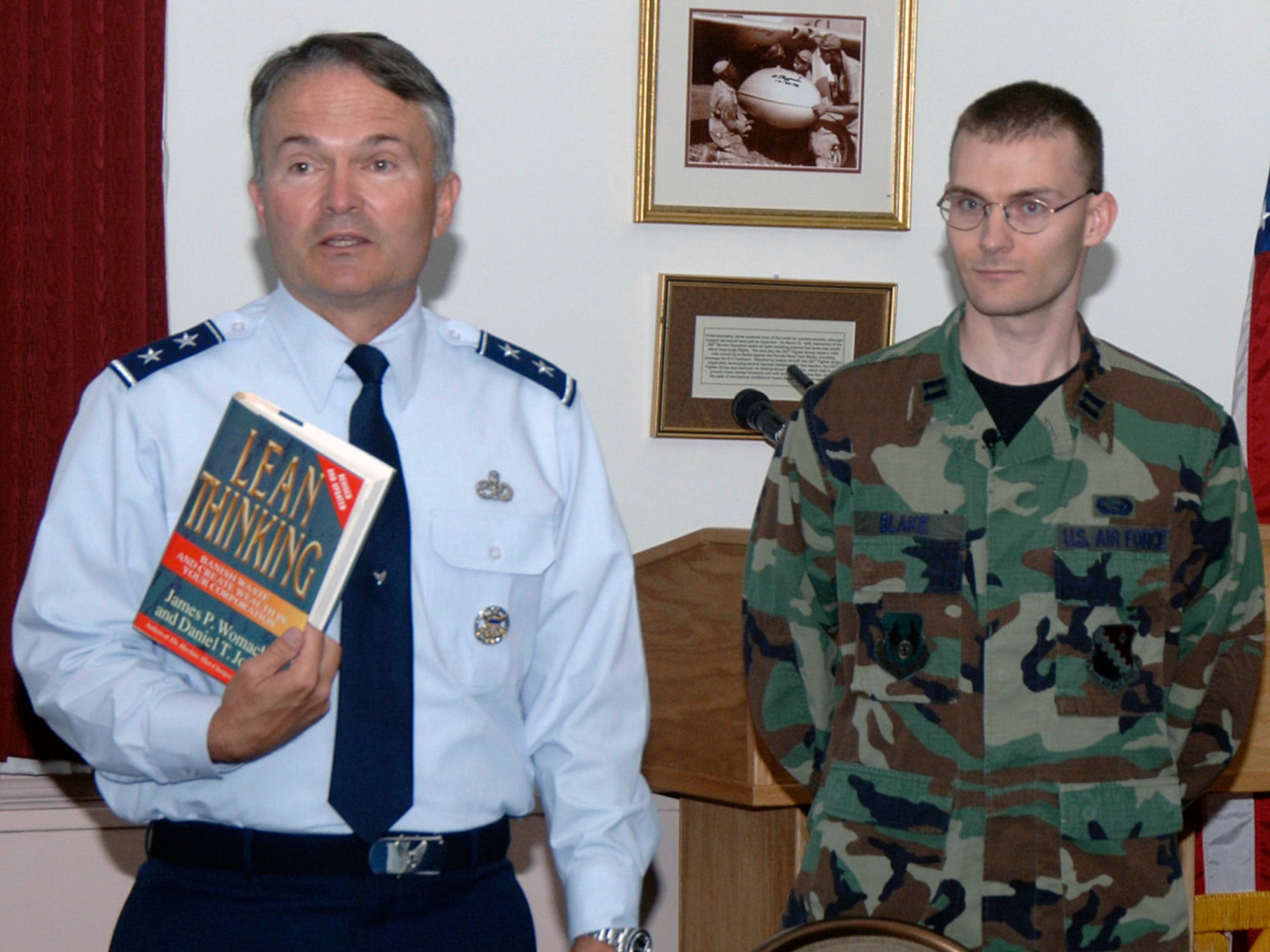 Electronic Systems Center Vice Commander Maj. Gen. Art Rooney discusses "Lean Thinking," at a Book of the Month Club meeting as Capt. Aaron Blake looks on. The book club, which brought people together to exchange ideas on process improvement and management, was one of several initiatives the general instituted during his tenure at ESC. (U.S. Air Force photo by Linda LaBonte Britt.)