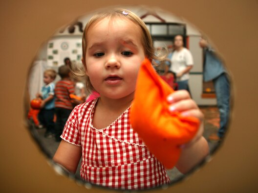 SHAW AIR FORCE BASE, S.C. -- Savannah, daughter of Tara and Staff Sgt. David Burke, 20th Equipment Maintenance Squadron, plays a bean bag toss game at the Shaw CDC Harvest Fest Oct. 25. (U.S. Air Force photo/Tech. Sgt. Kevin Williams)