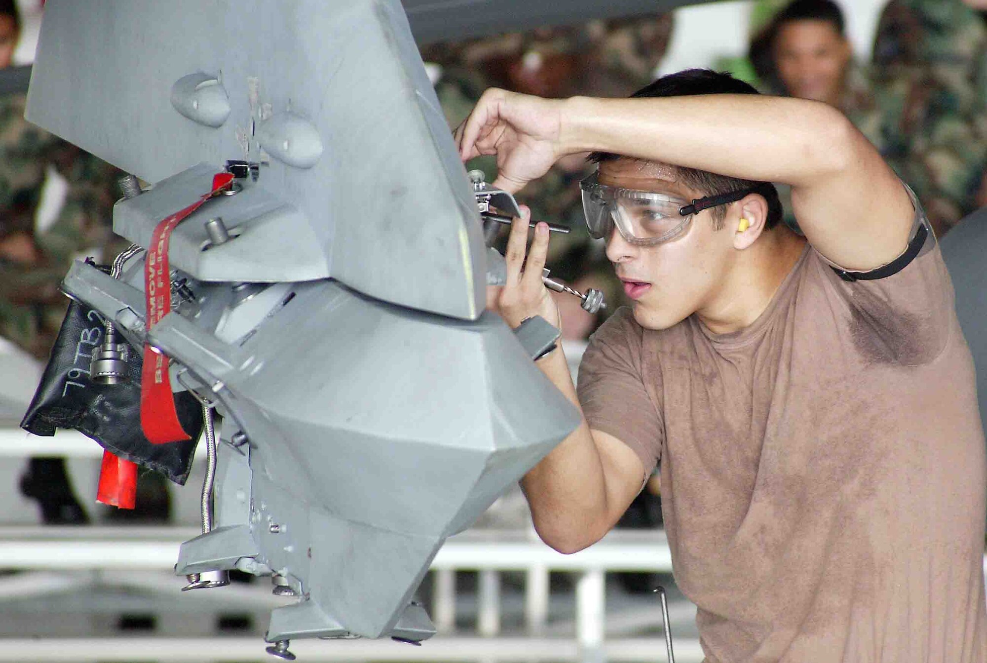 SHAW AIR FORCE BASE, S.C. -- Senior Airman Eric Solon, 77th Aircraft Maintenance Unit weapons loader, safety wires the impulse cartridge retainers on the F-16CJ wing pylon during a weapons load crew competition Oct. 19. "The weapons load crew competition program is designed to promote morale and to increase proficiency, knowledge, professionalism and integrity," said Jeffrey McLaughlin, 20th Maintenance Group loading standardization crew member. (U.S. Air Force photo/Staff Sgt. John Gordinier)