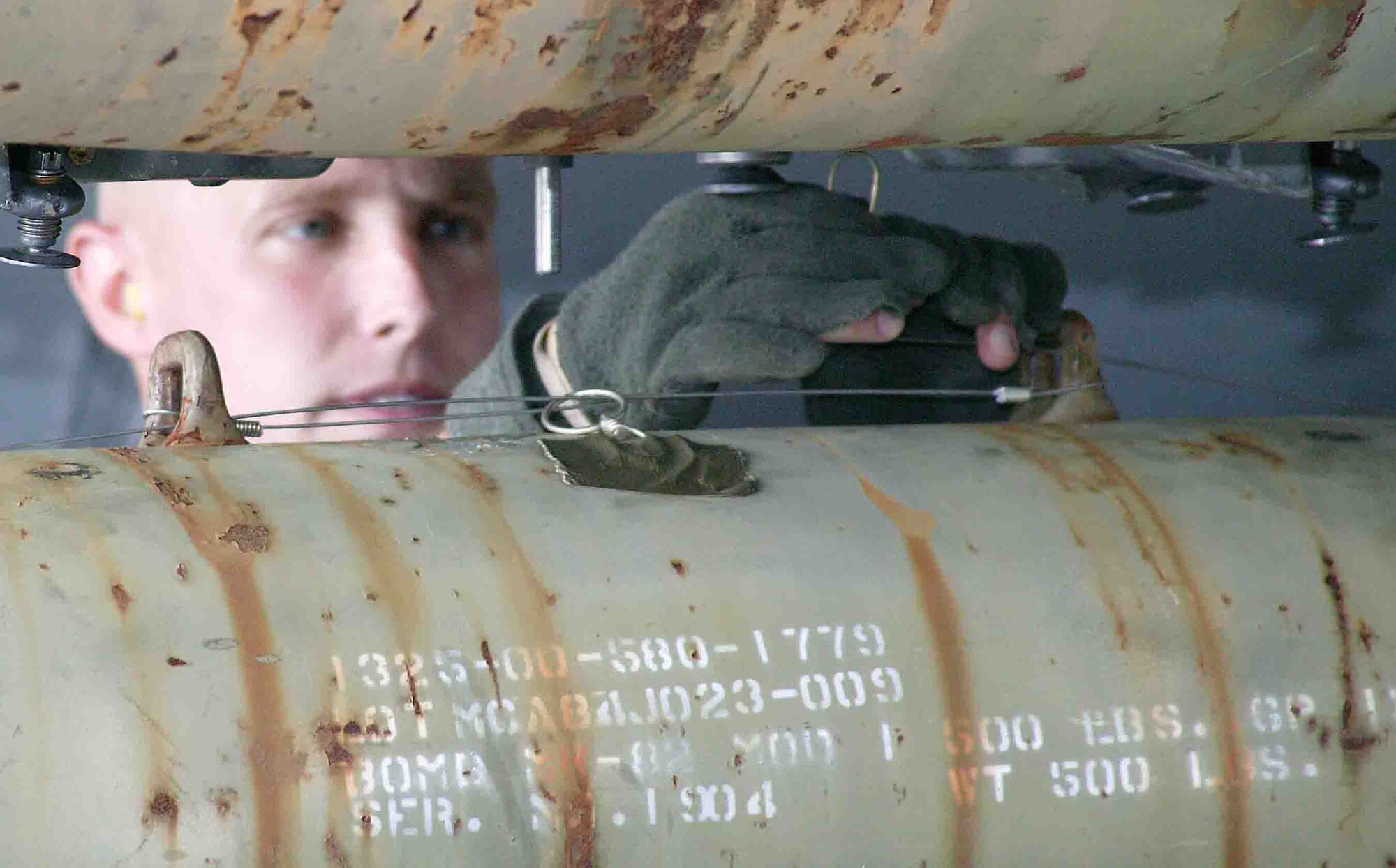 SHAW AIR FORCE BASE, S.C. -- Staff Sgt. Samuel McDonnell, 77th Aircraft Maintenance Unit weapons loader, connects the arming loop to the aft arming solenoid for the tail fuze during a weapons load crew competition Oct. 19. "The weapons load crew competition program is designed to promote morale and to increase proficiency, knowledge, professionalism and integrity," said Jeffrey McLaughlin, 20th Maintenance Group loading standardization crew member. (U.S. Air Force photo/Staff Sgt. John Gordinier)