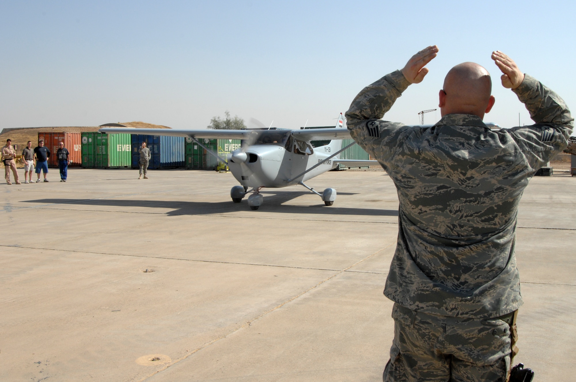 KIRKUK REGIONAL AIR BASE, Iraq -  Staff Sgt Erik Ruppert, 52nd Expeditionary Flight Training School crew chief, marshals Lt. Colonel Mark Bennett, 52 EFTS Commander, and General Alaa, Iraqi Air Force, for the first flight of the new aircraft in service , Oct. 19.  Two cesnas were shipped in for the training school only four days ago and the maintenance personnel worked around the clock to get both of them operational.  These fixed wing cesnas will be the first aircraft used in training of the new Iraqi Air Force pilots. 
(U.S. Air Force Photo/Senior Airman Jeremy McGuffin)