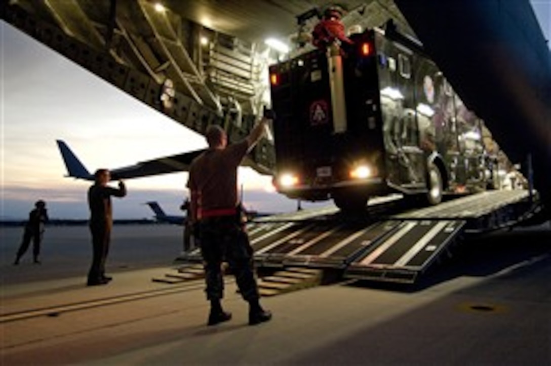 U.S. Army equipment is unloaded from an Air Force C-17 Globemaster III aircraft at March Air Force Base, Calif., Oct. 24, 2007. The equipment is part of a federal support package used to assist federal, state and local agencies responding to the California wildfires.  