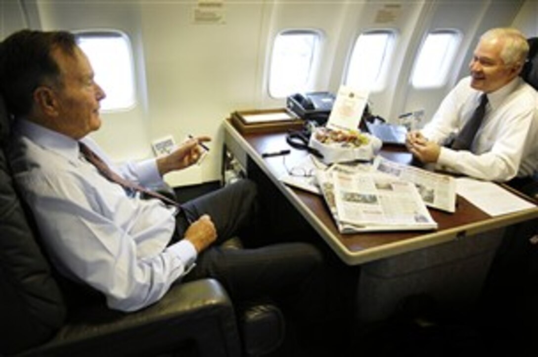 Defense Secretary Robert M. Gates shares a laugh with President George H. W. Bush, aboard a C-32 Aircraft en route College Station, Texas, Oct. 26, 2007. Bush presented Gates with the George Bush Award for Excellence in Public Service.